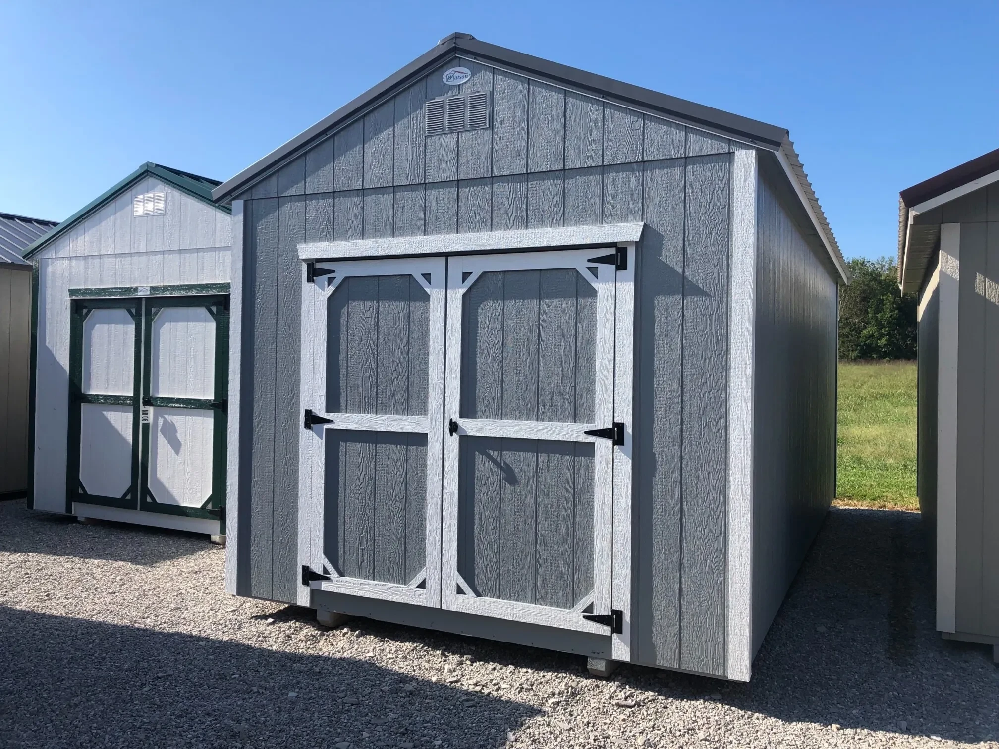 The front view of a grey wood shed