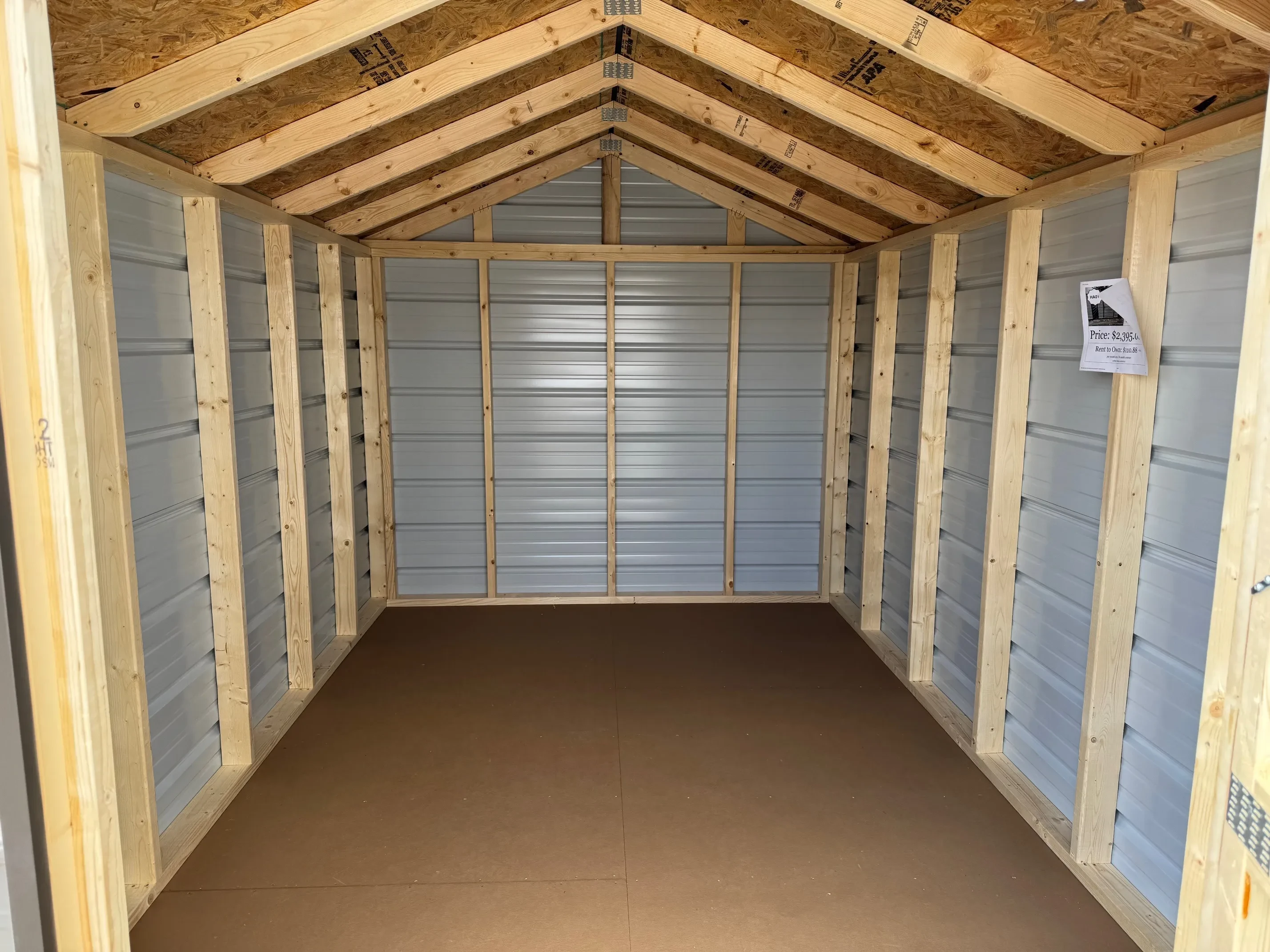 Inside of 8 x 12 Economy metal utility shed, single metal door clay base with burnished slate roof and trim.