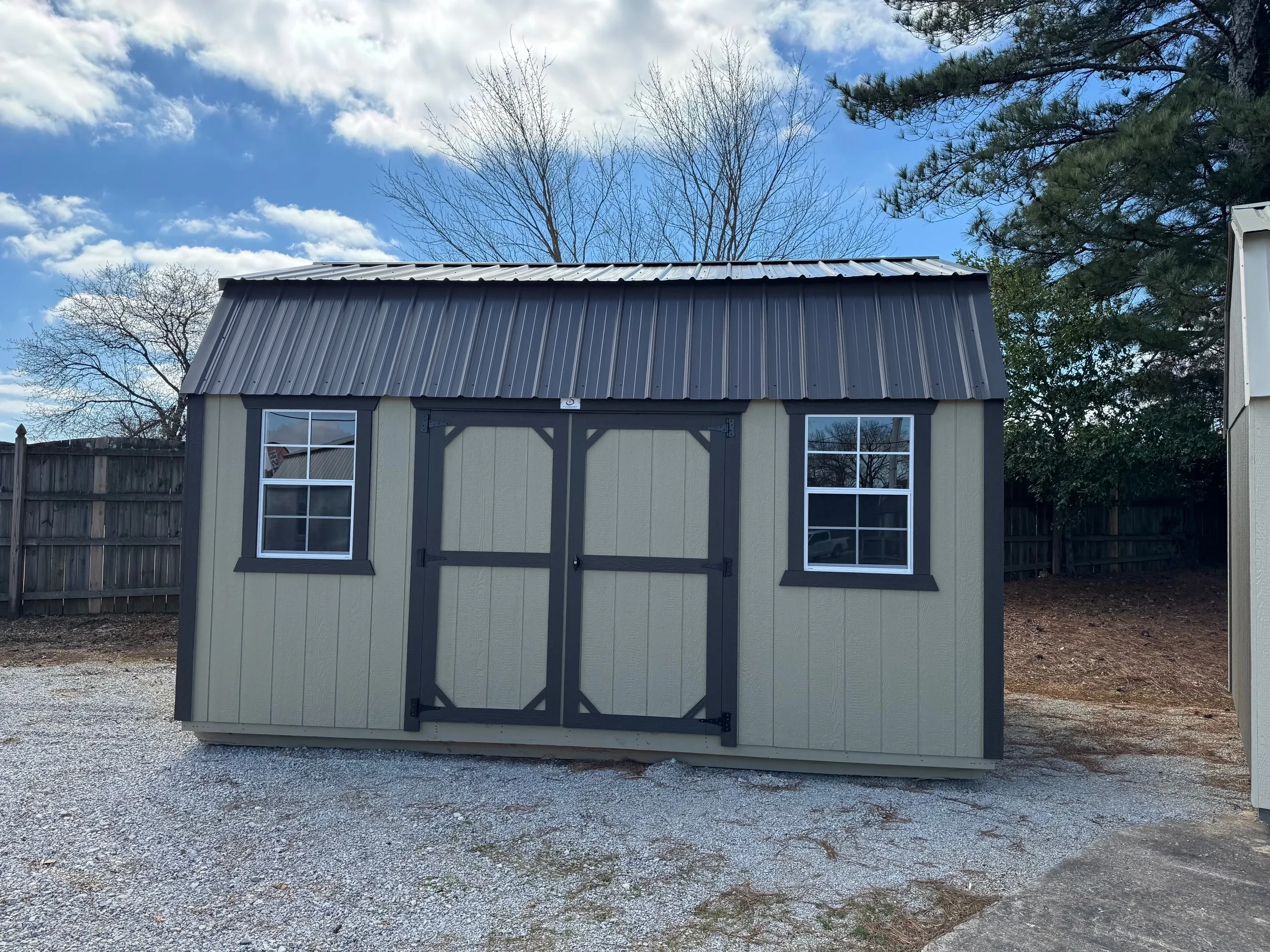 Outside of classic wood 12x16 side lofted barn with double doors and 2 windows