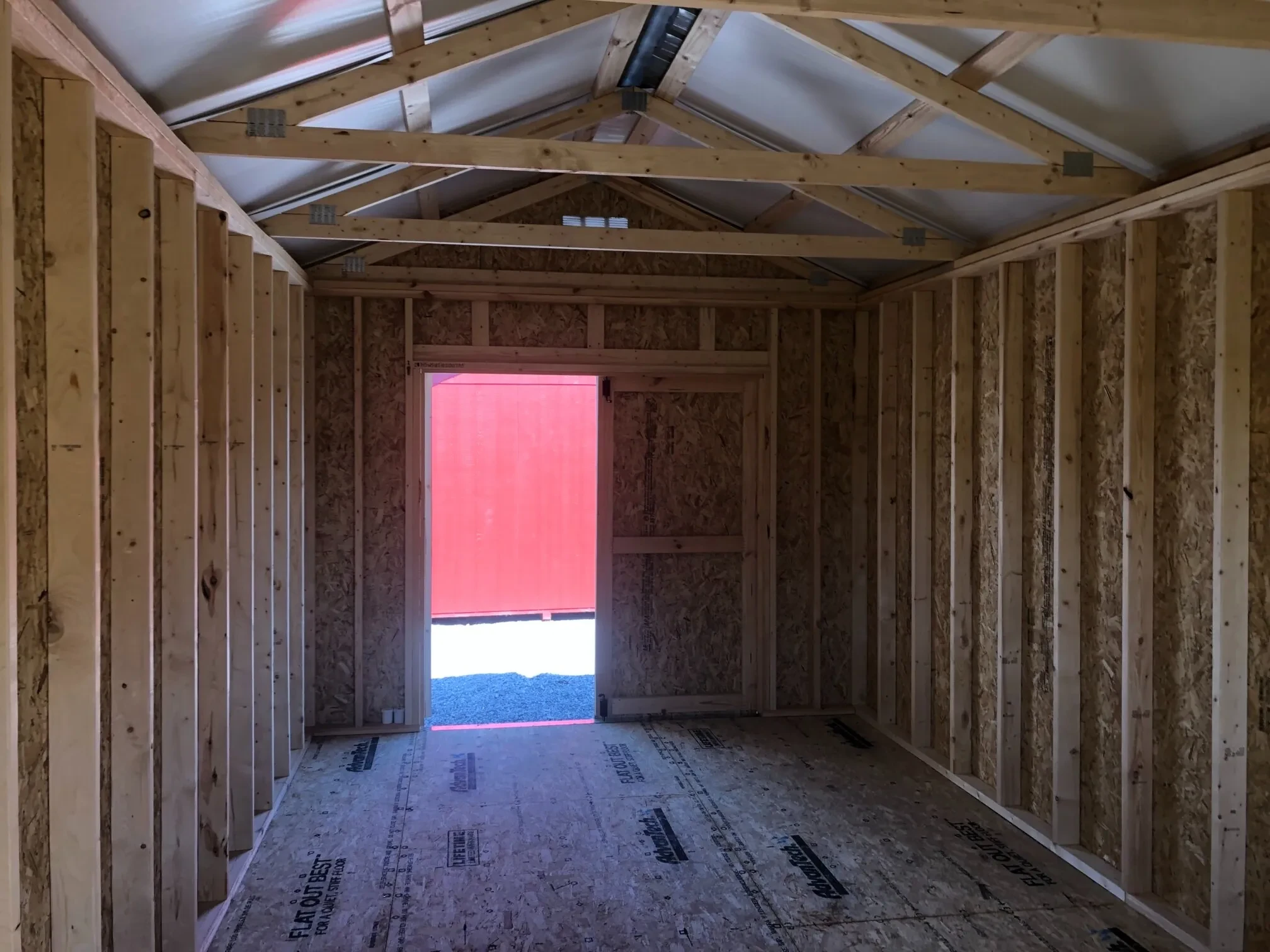 The inside of a wood shed showing the double doors which are open