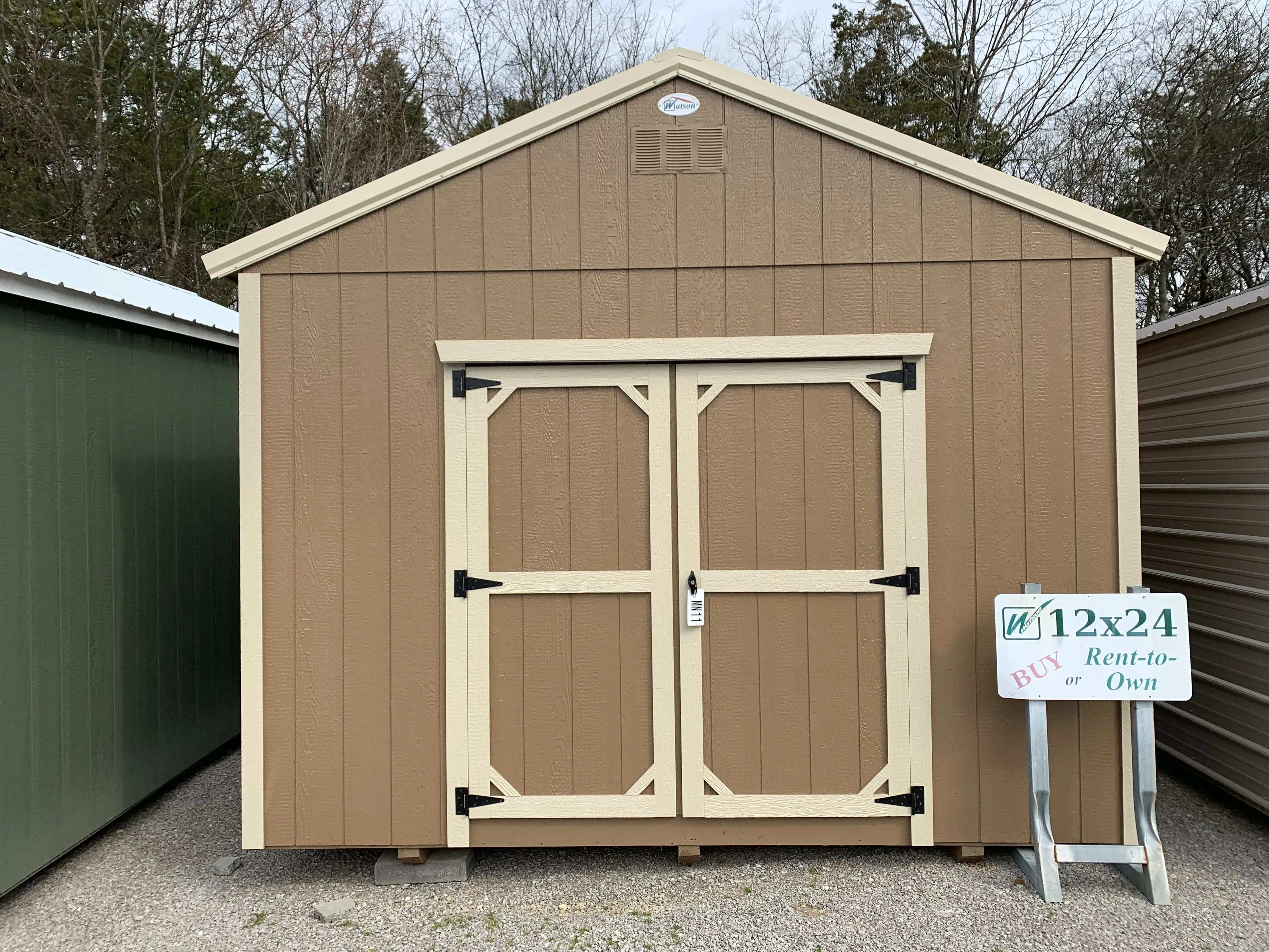 12x24 utility shed. Pinbark in color with stone trim and metal roof.