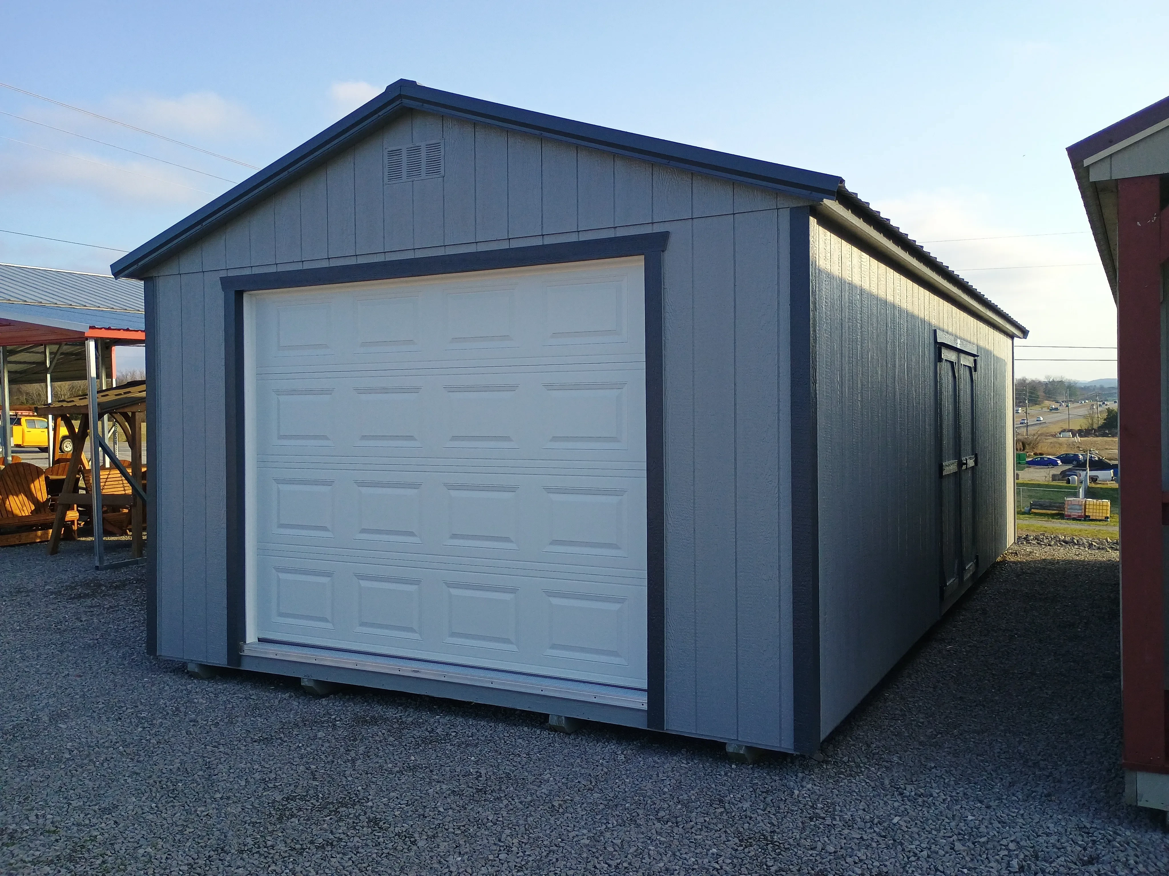 14x28 wood garage exterior with overhead garage door and double doors on the side and metal roof