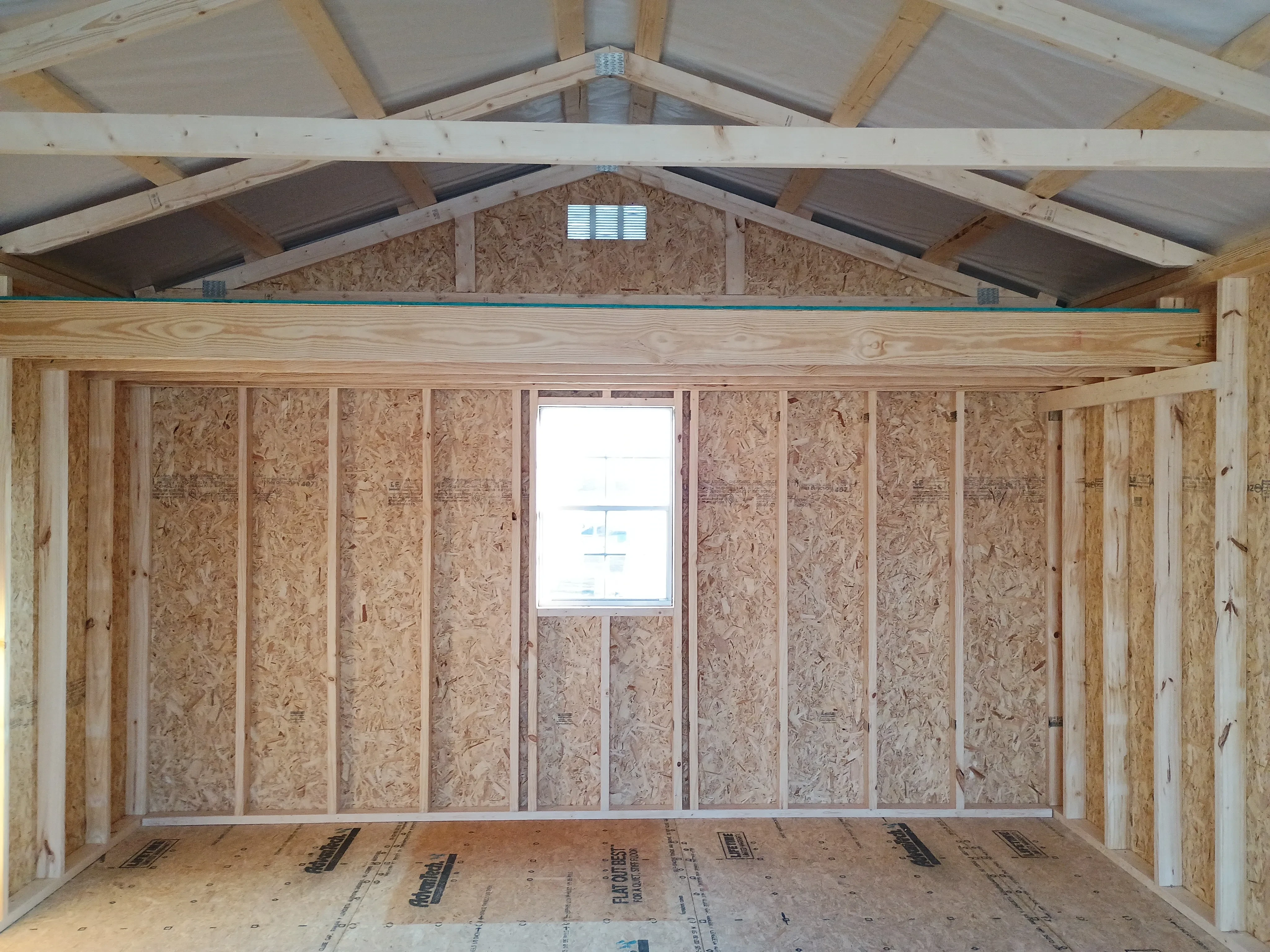 14x28 wood garage interior showing loft and window