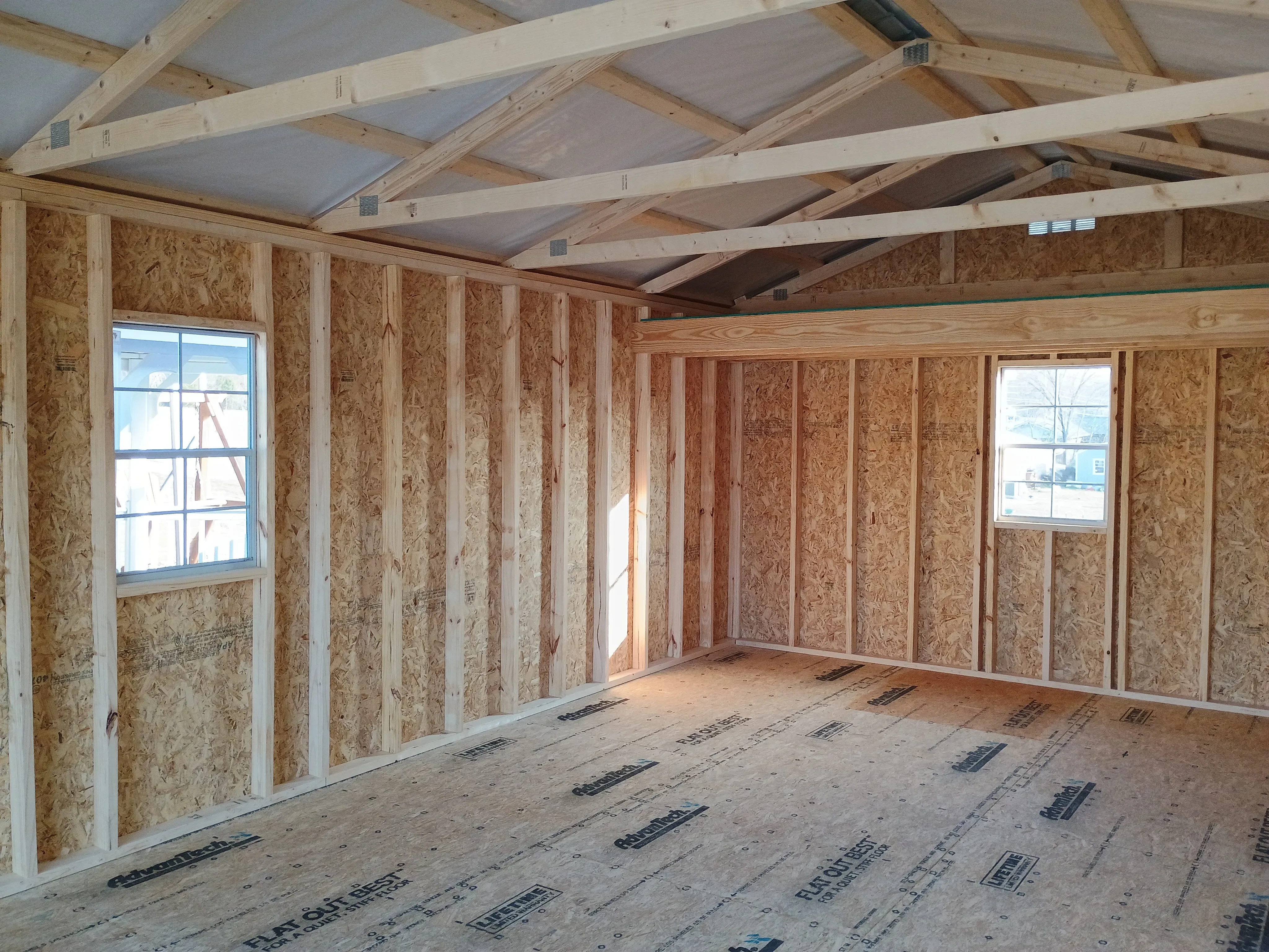 14x28 wood garage interior showing loft and 2 windows