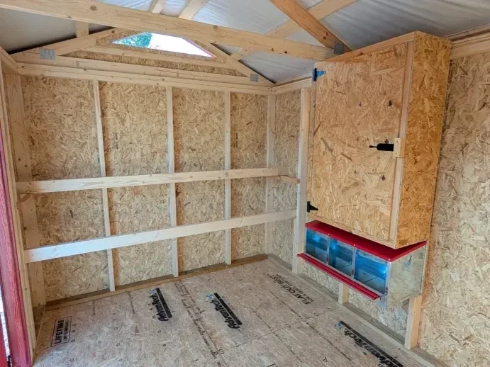 inside showing nesting boxes, roosting poles and cabinet