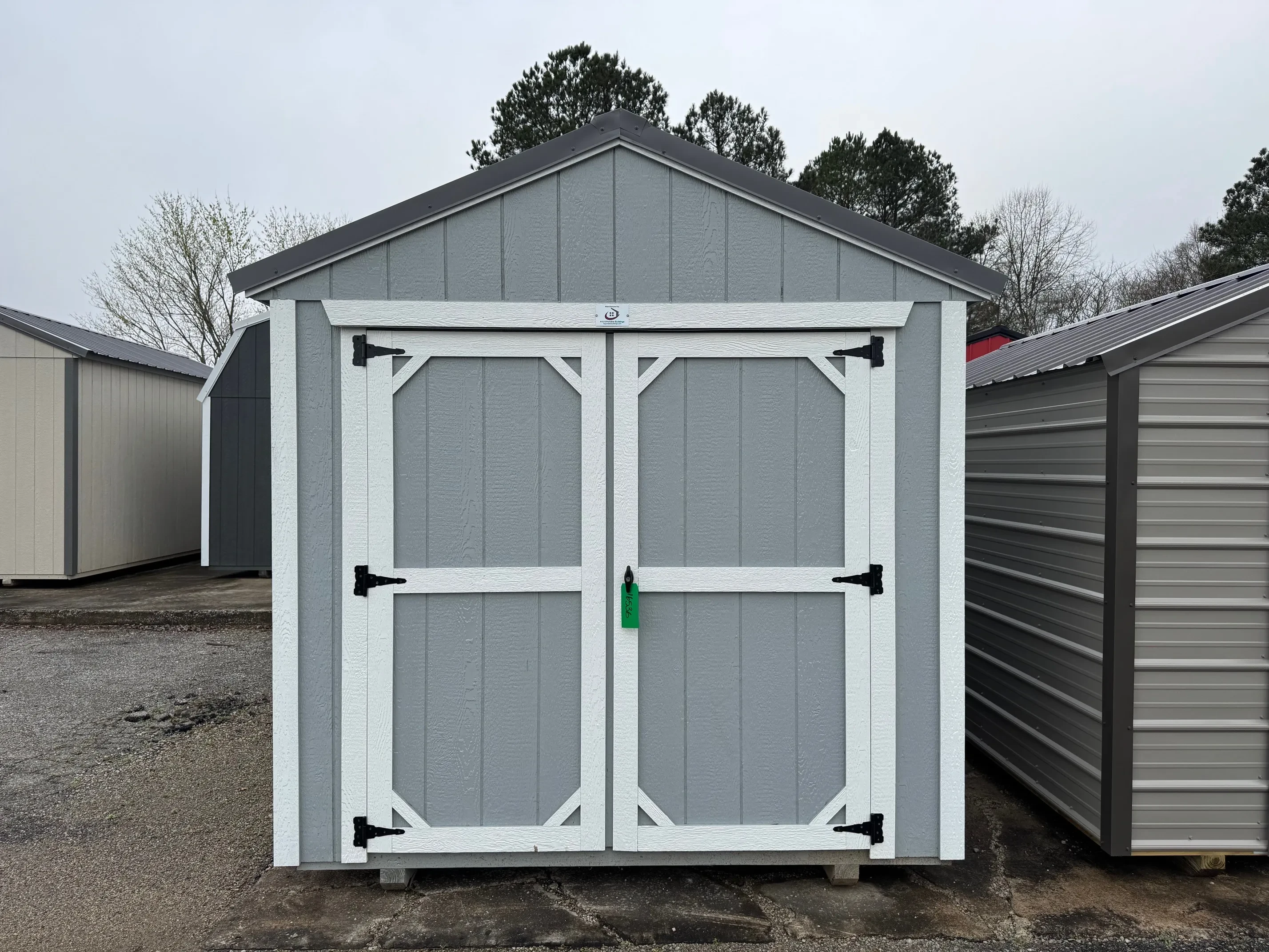 Outside of 8 X 16 Zook Gray Classic Wood Utility Shed With Double Doors, White Trim and Charcoal Roof