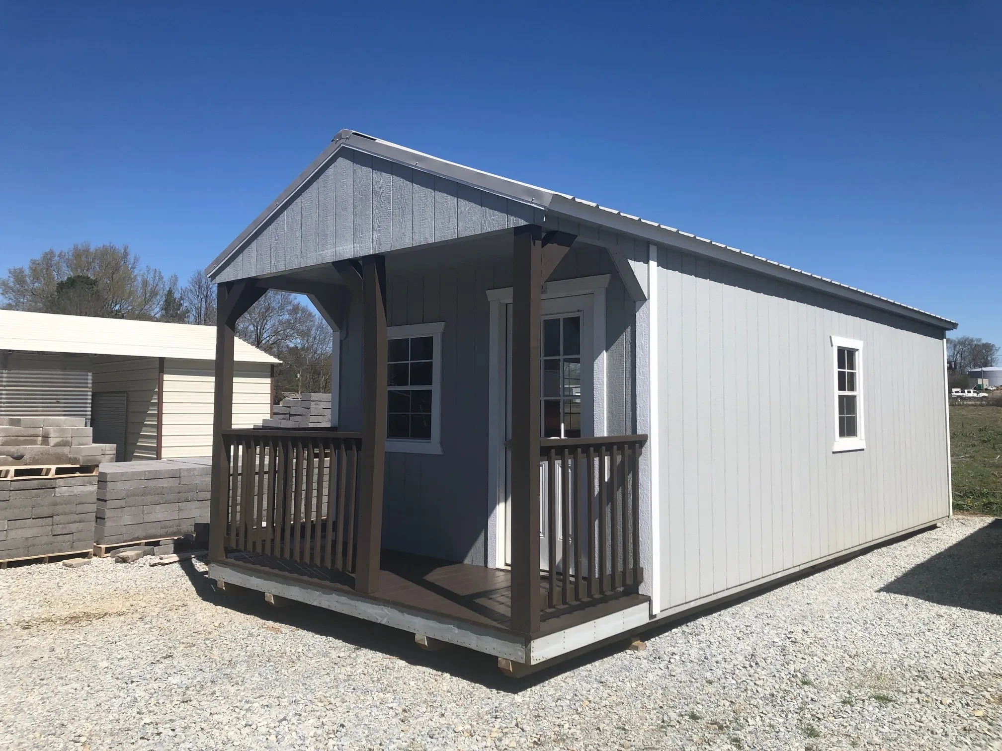 exterior of 12x28 cabin showing a porch and door and windows