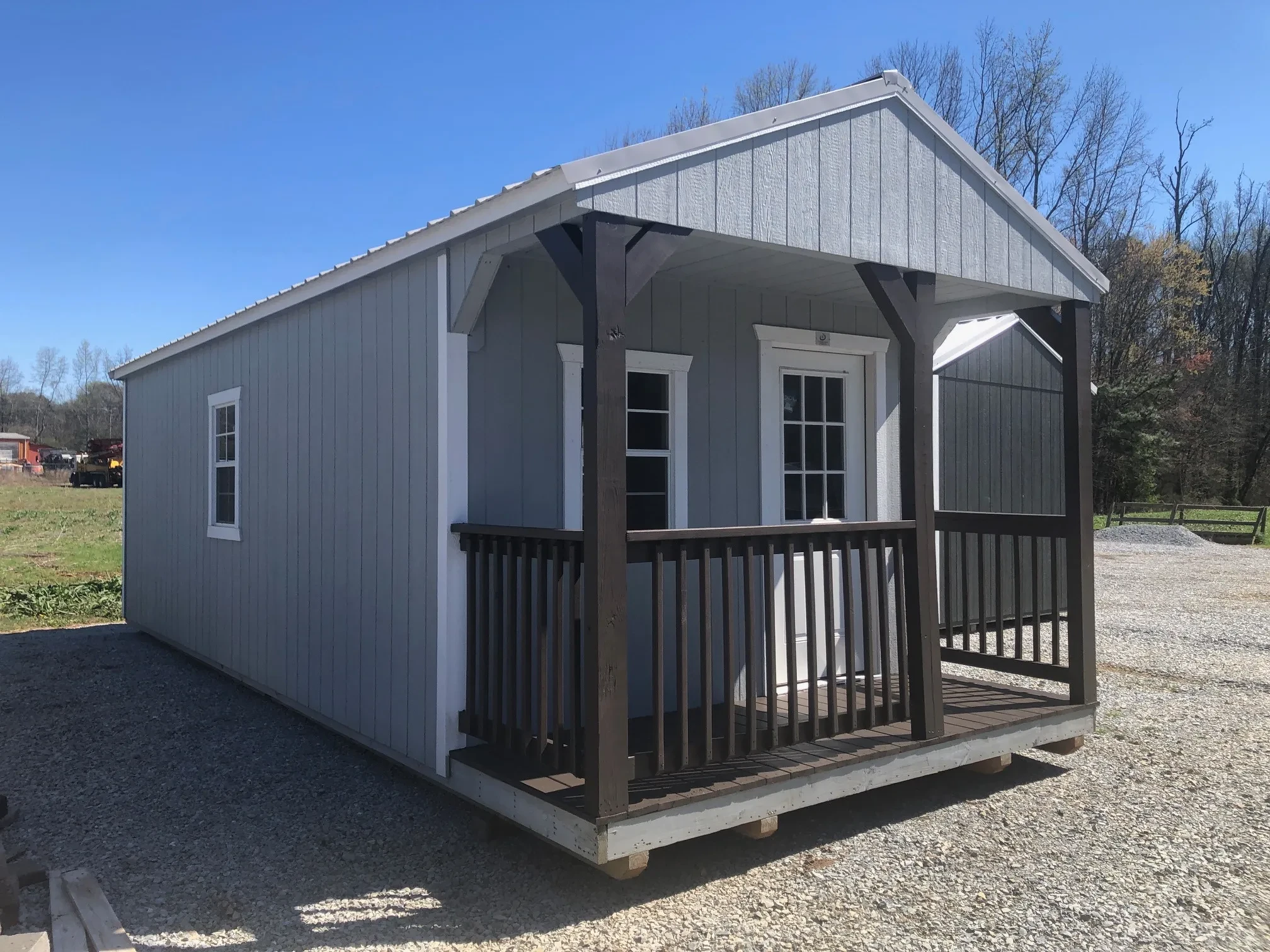 exterior of 12x28 cabin showing a porch and door and windows from another angle