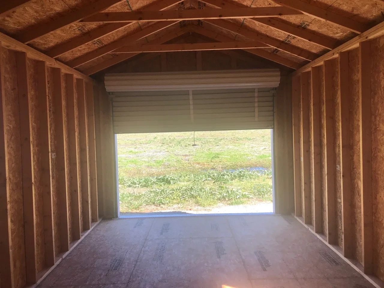 interior of 12x28 cabin showing the roll up door