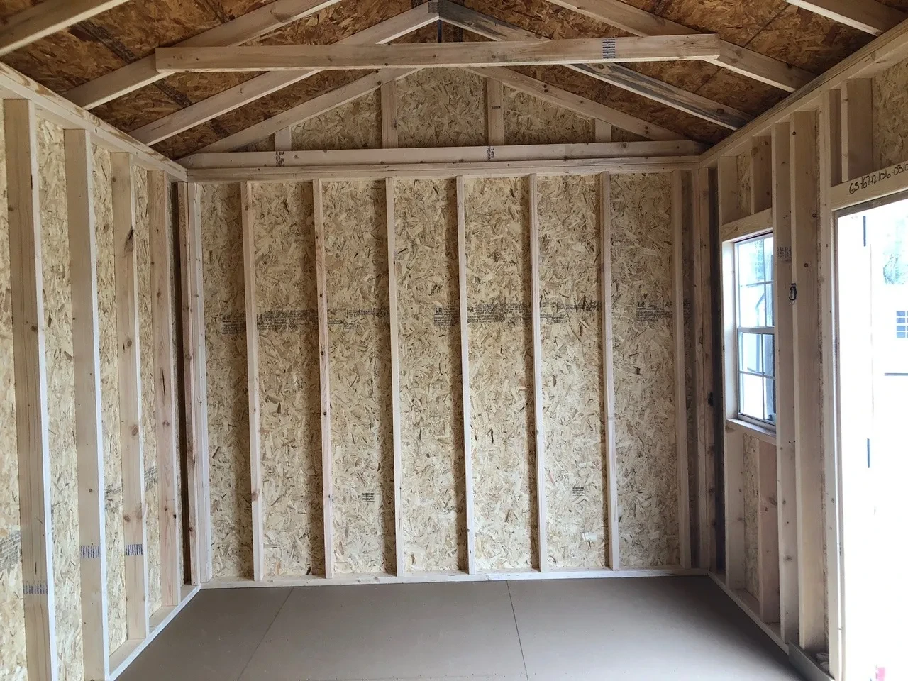 interior of 10x16 garden shed showing open door and window