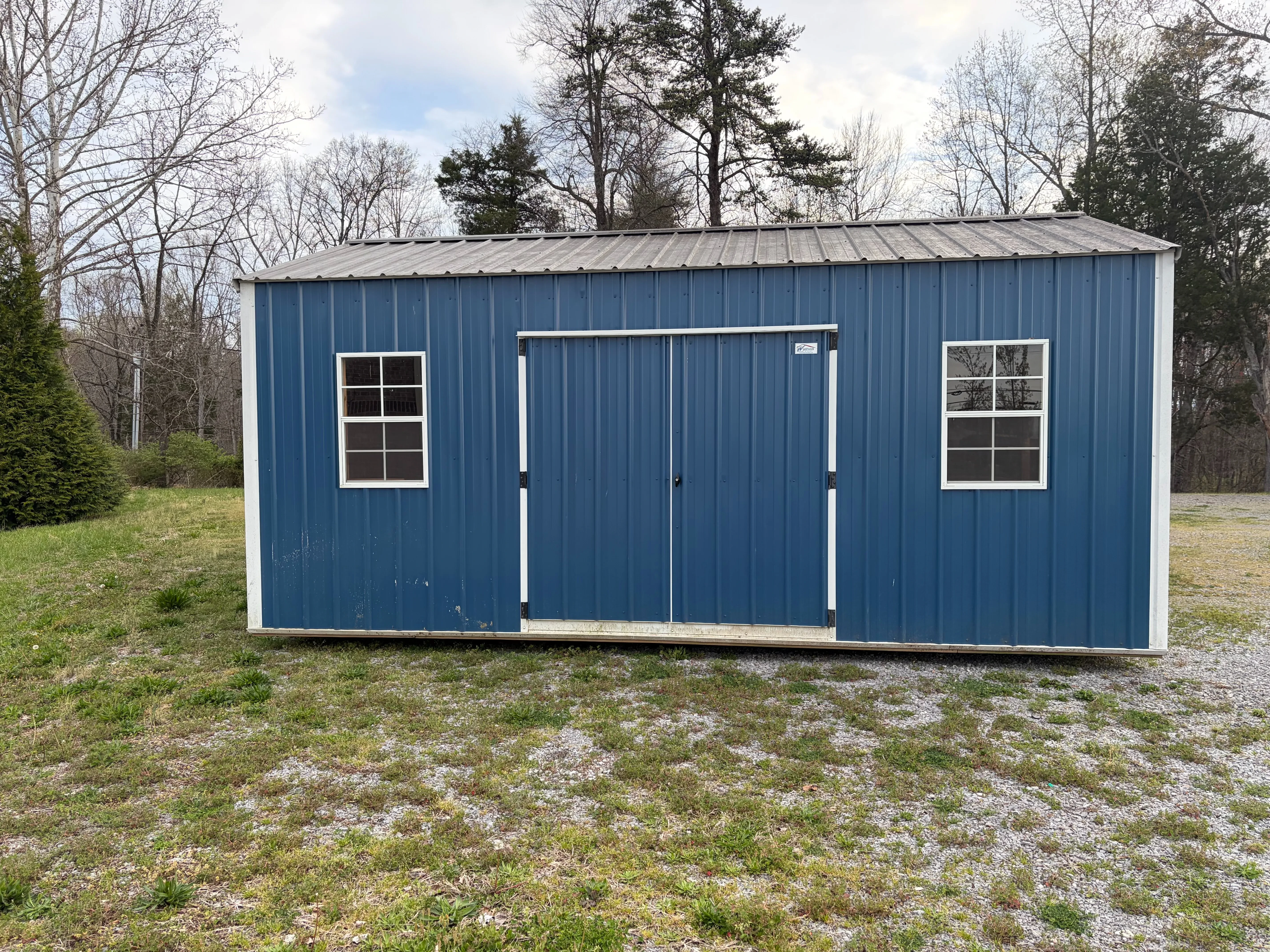 exterior front view of the building showing (2) windows & double door
