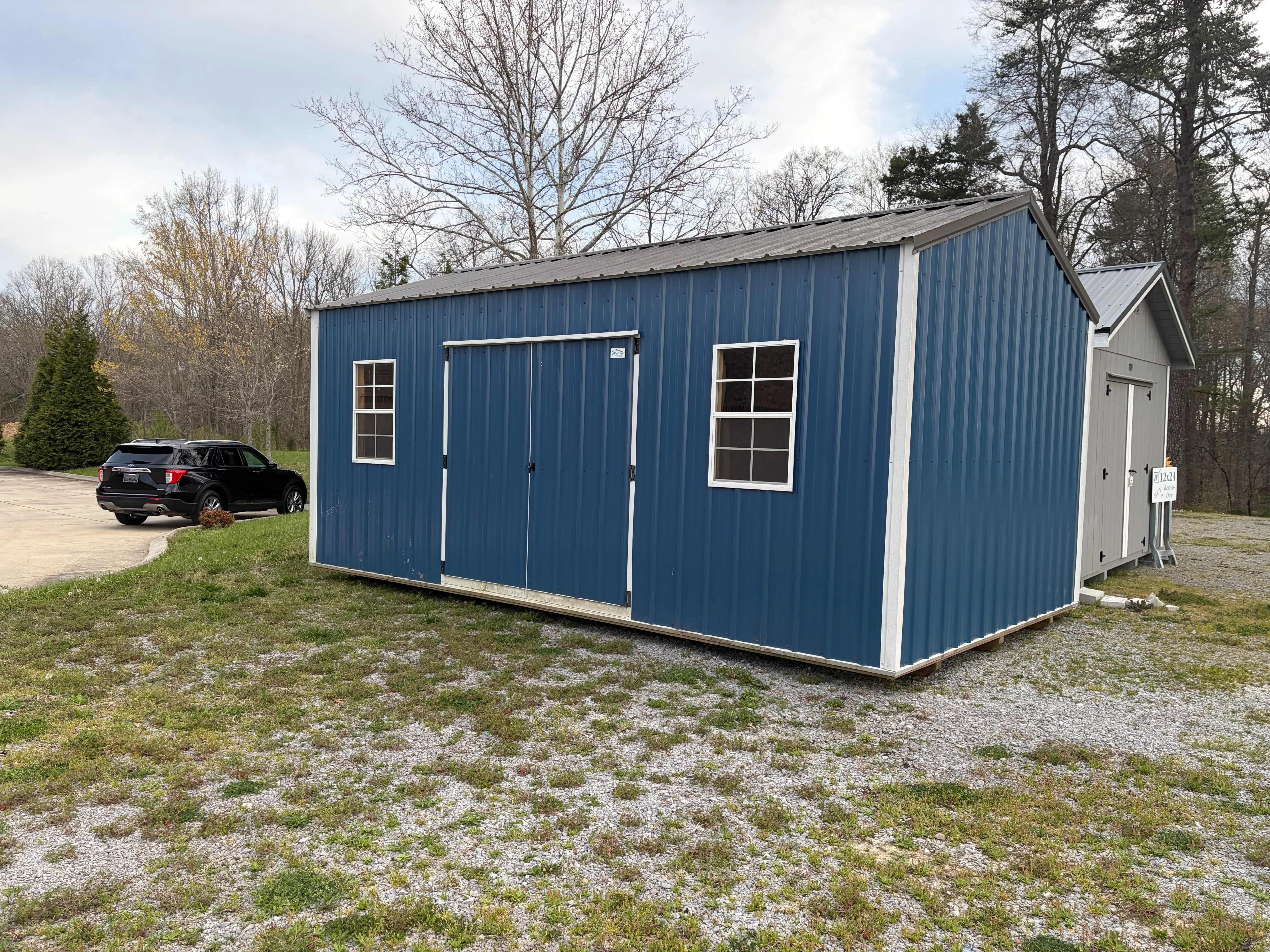 exterior side view gallery blue siding, white trim & charcoal roof