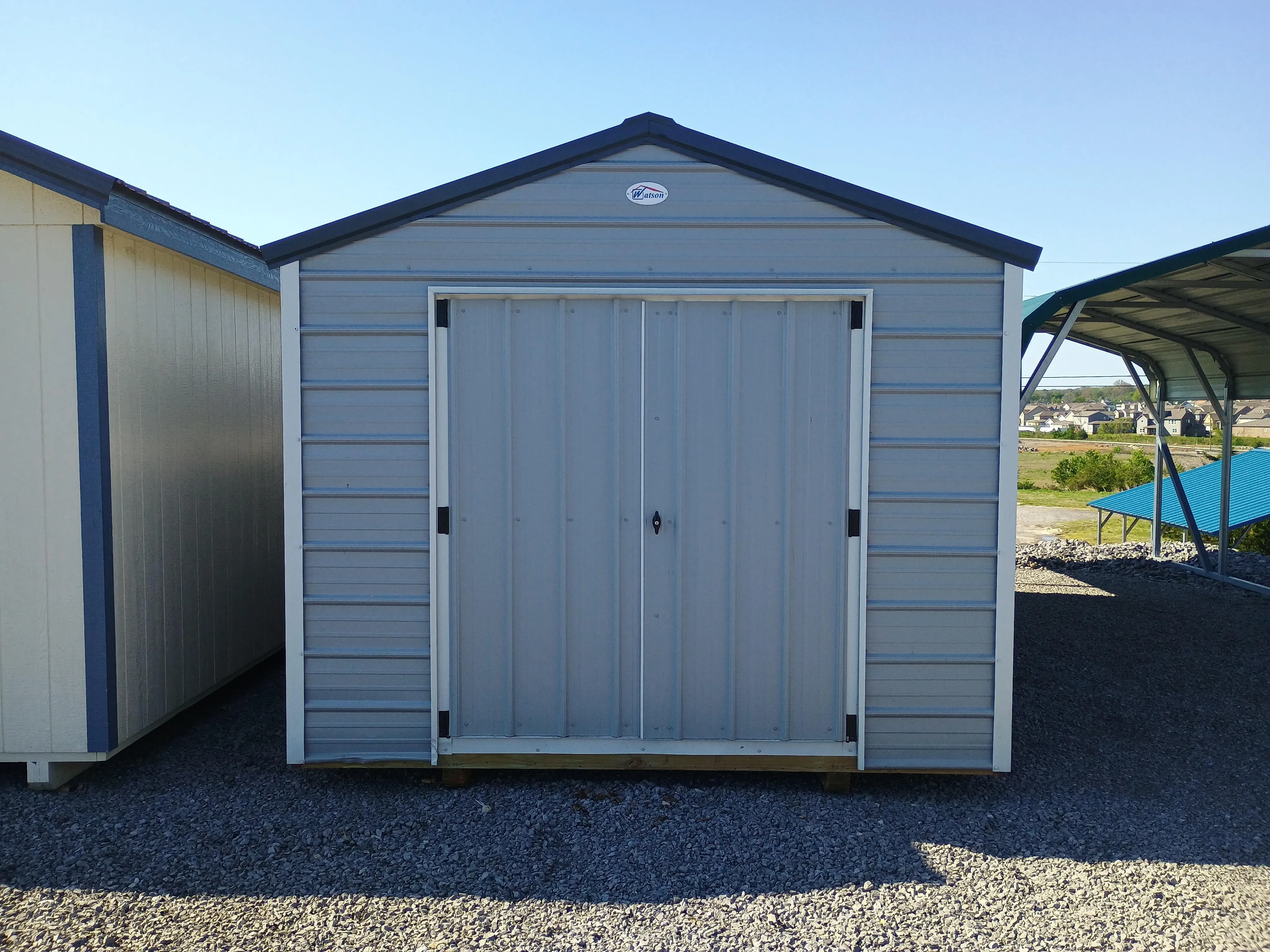 Exterior of used REPO 10x20 Value Metal Shed in Light Gray body with White trim and Slate Gray roof.