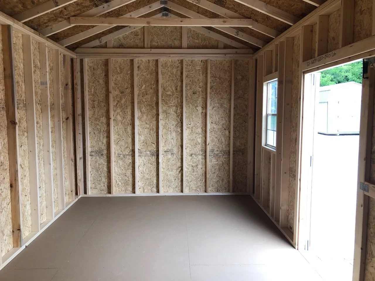 interior of shed showing a window and the open double doors