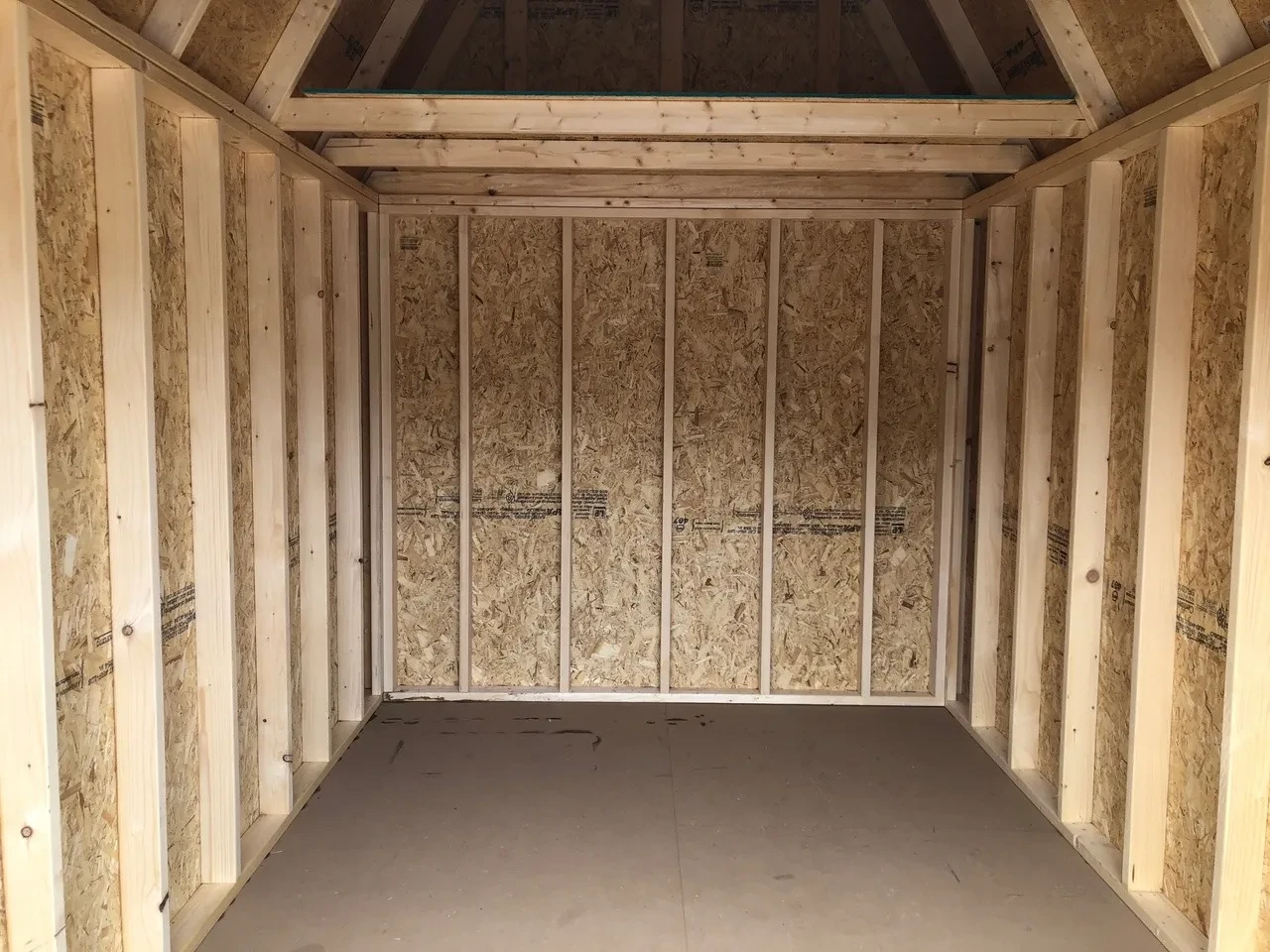 inside of lofted barn showing the floor and a loft