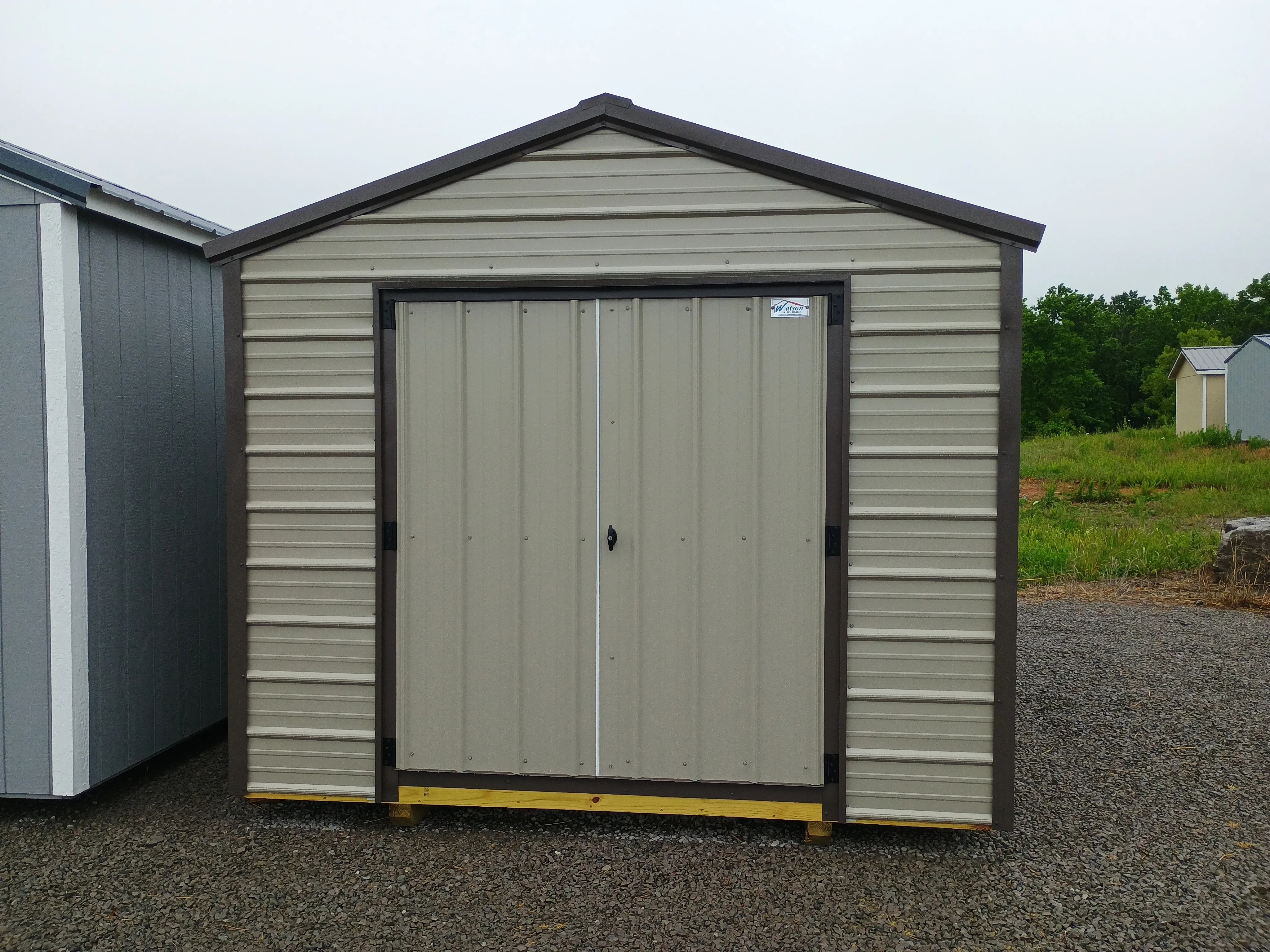 Outside of clay value metal shed with bronze roof and trim, and 66" double doors