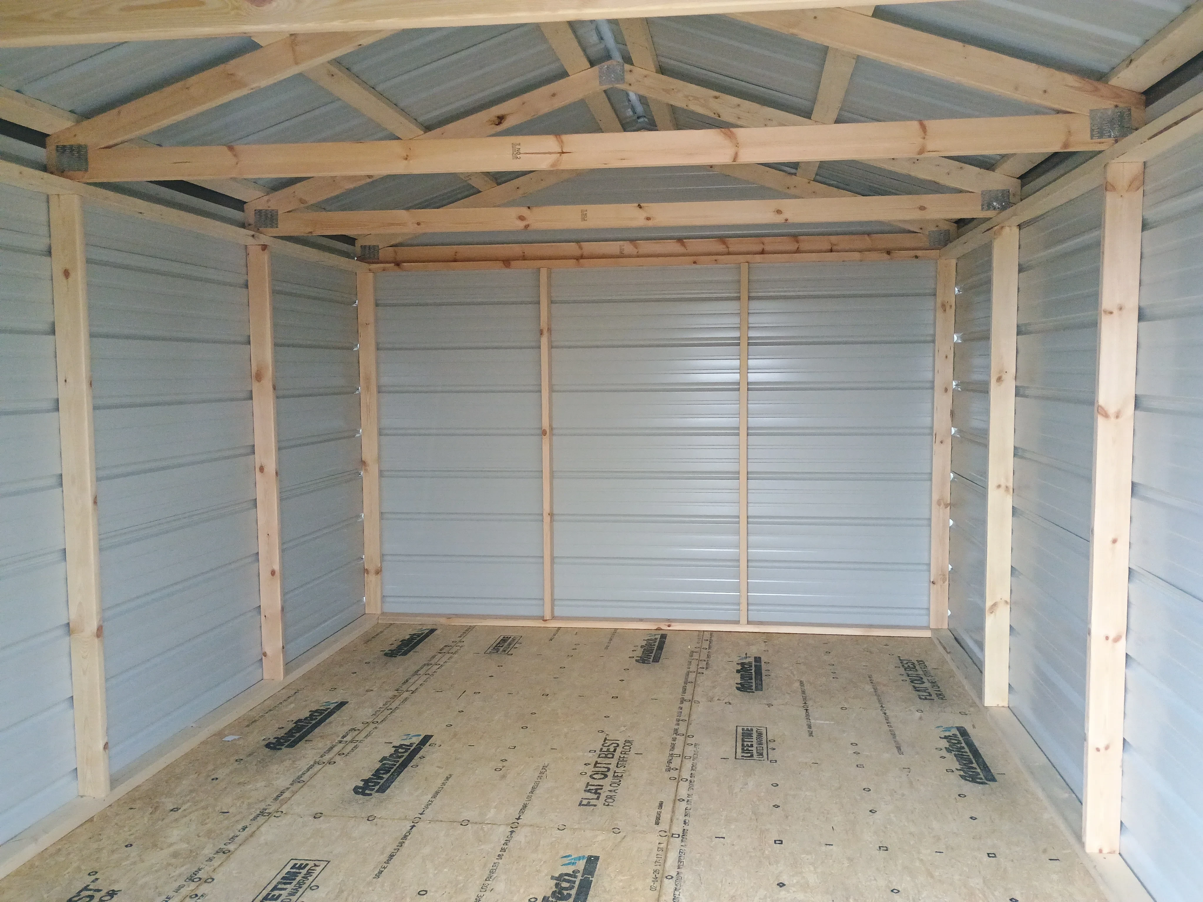 Inside of value metal shed, showing mainly the walls and flooring
