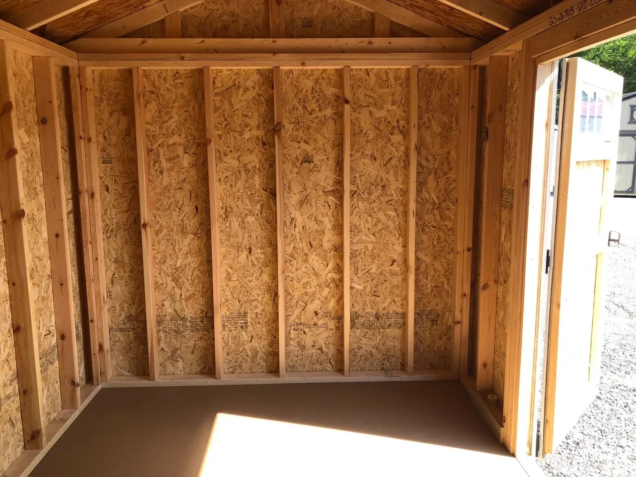 interior of 8x12 garden shed showing half of door