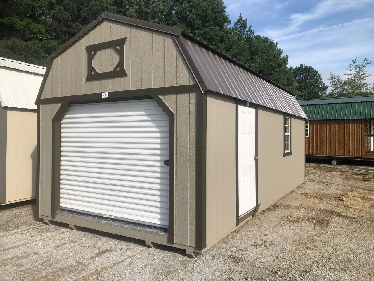 exterior of 12x24 lofted barn garage showing rollup door and entry door and a window