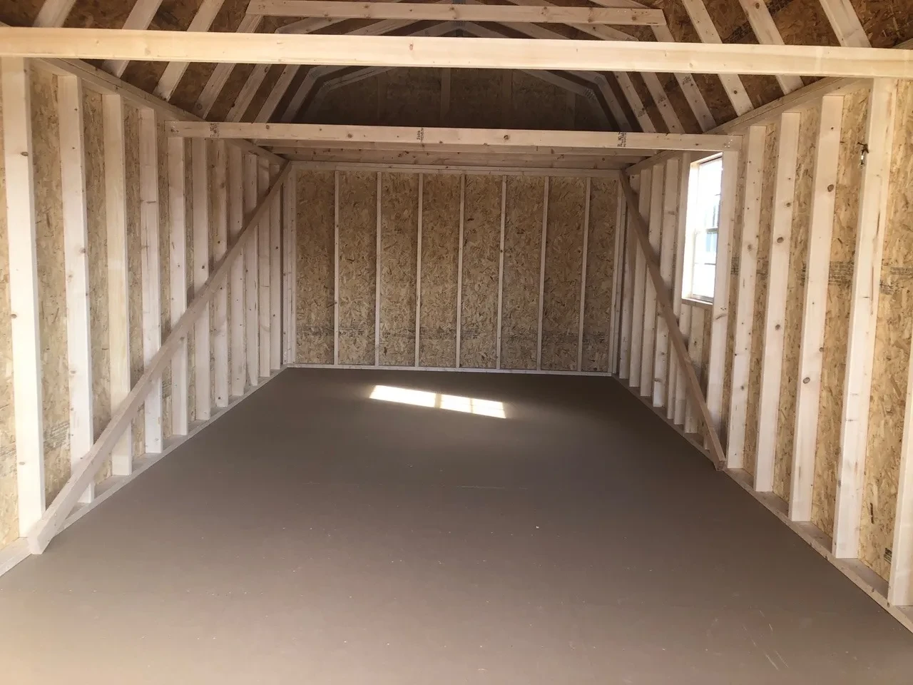 interior of 12x24 lofted barn garage showing a loft and a window