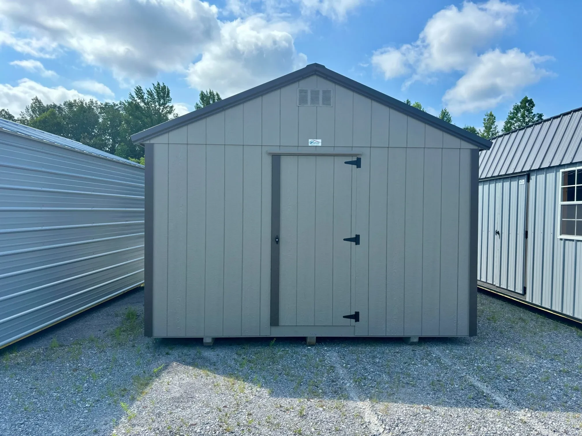 The back of a dog kennel showing a walk-in door