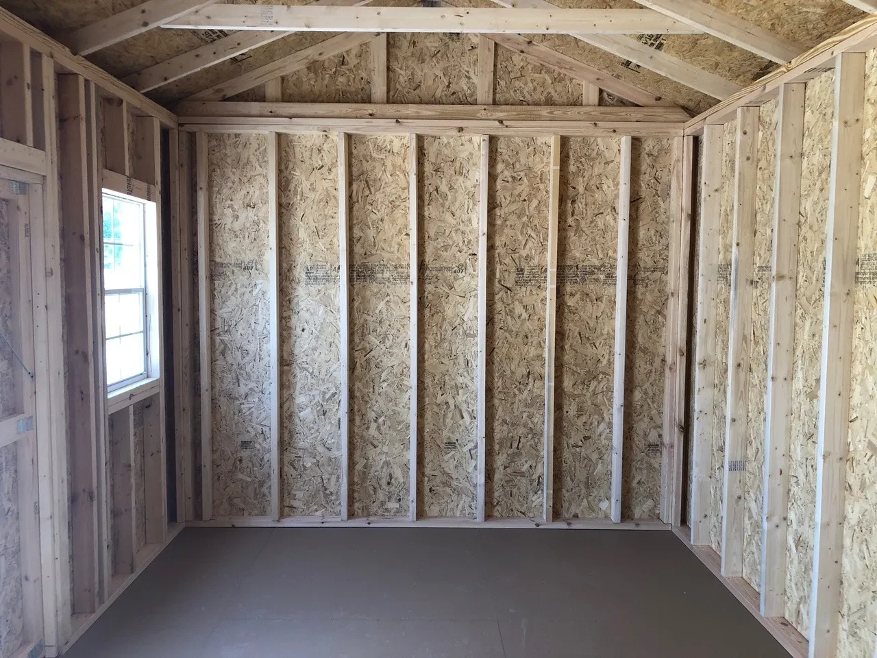 interior of 10x16 garden shed showing floor and 1 window