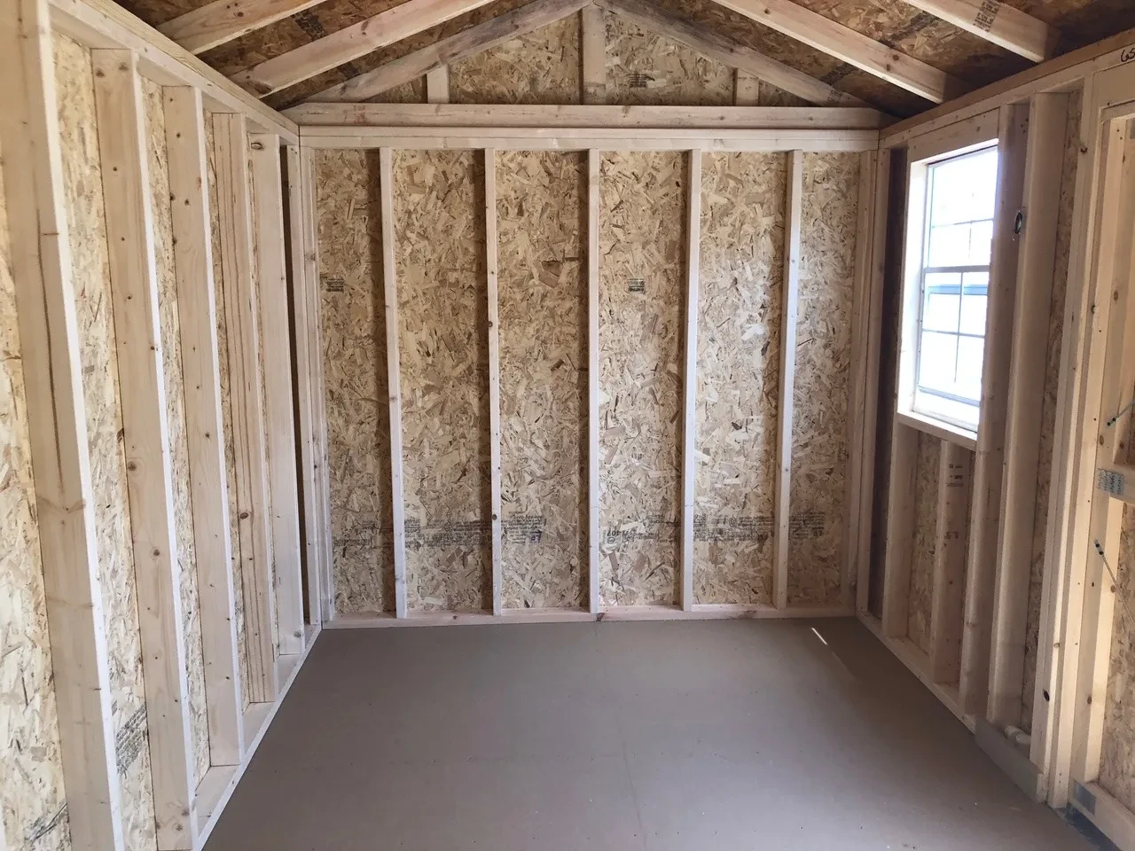 interior of 8x16 garden shed showing the floor and 1 window