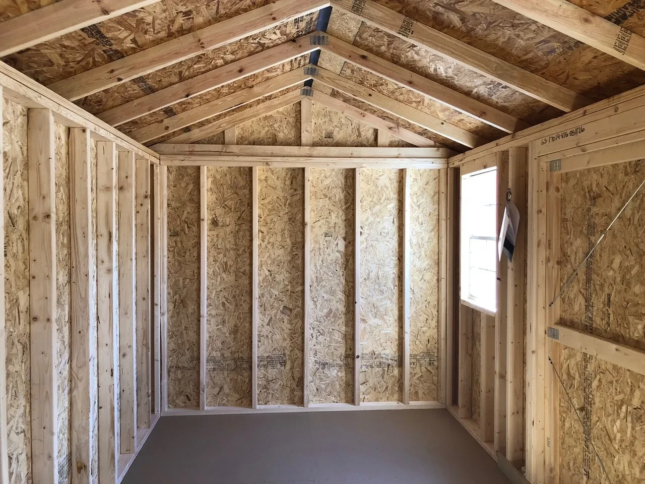 interior of 8x16 garden shed showing the floor and 1 window