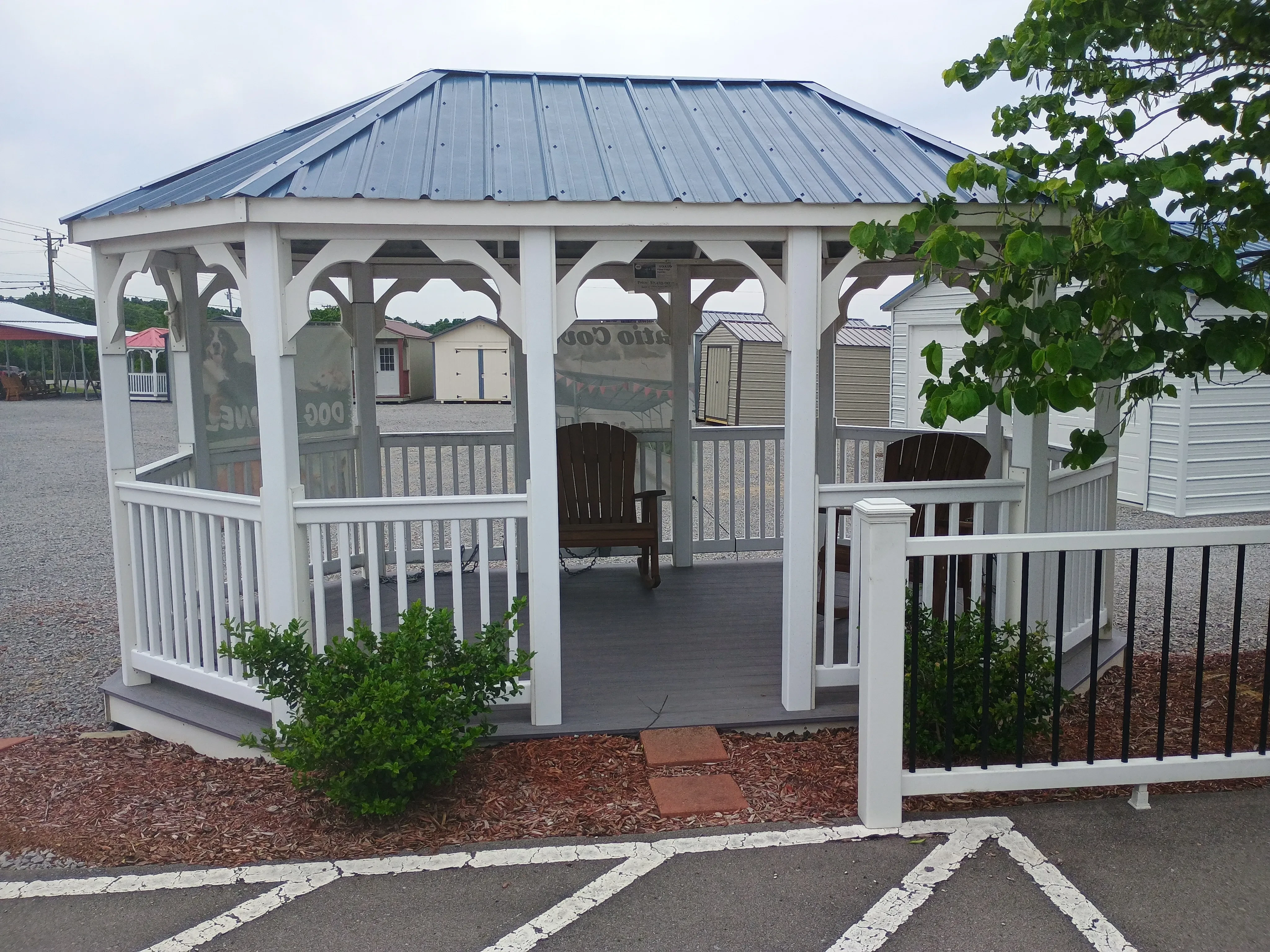 Outside of 10x16 value vinyl gazebo with gallery blue metal roof.
