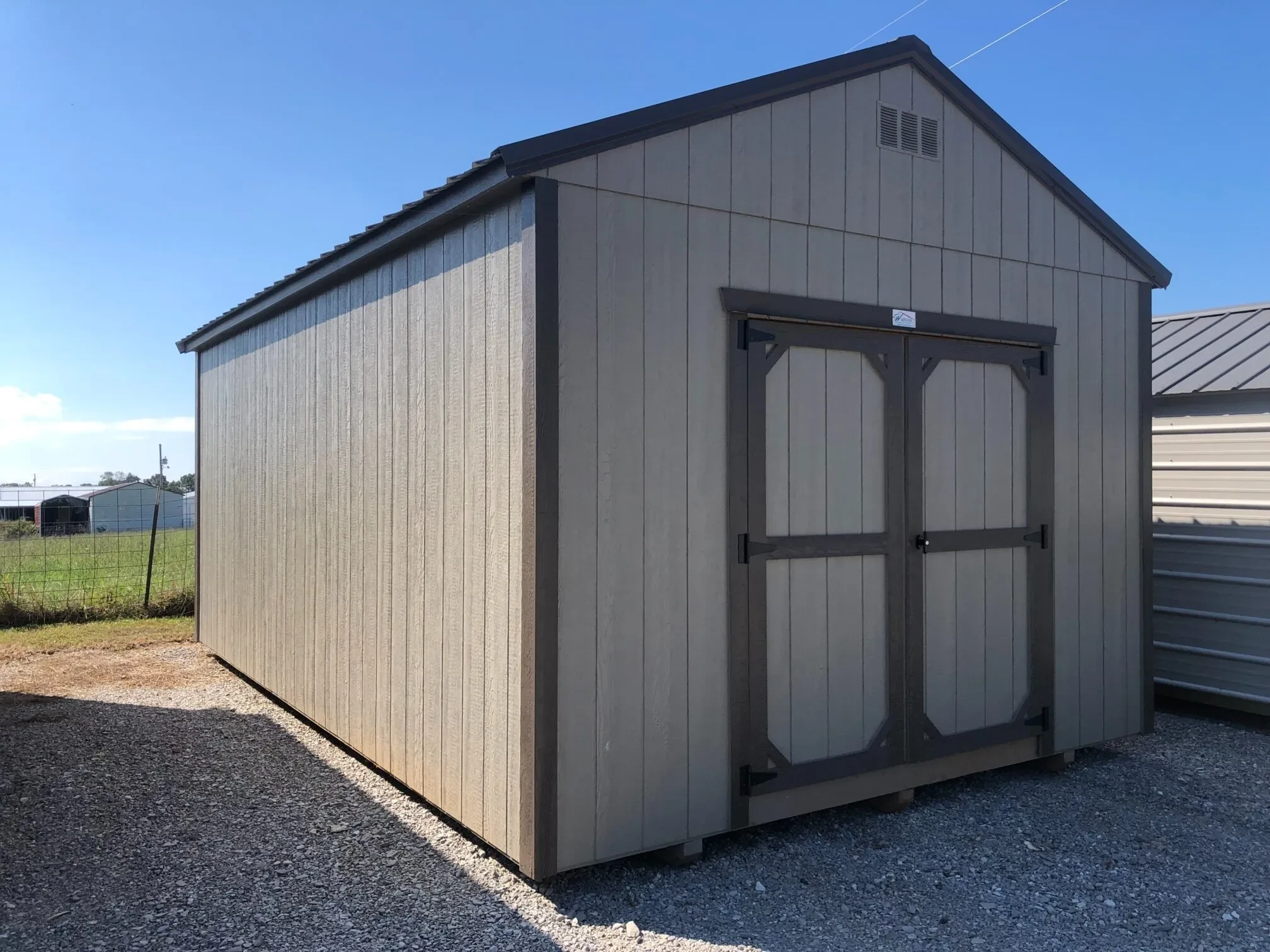 The front corner view of a wood shed painted bronze