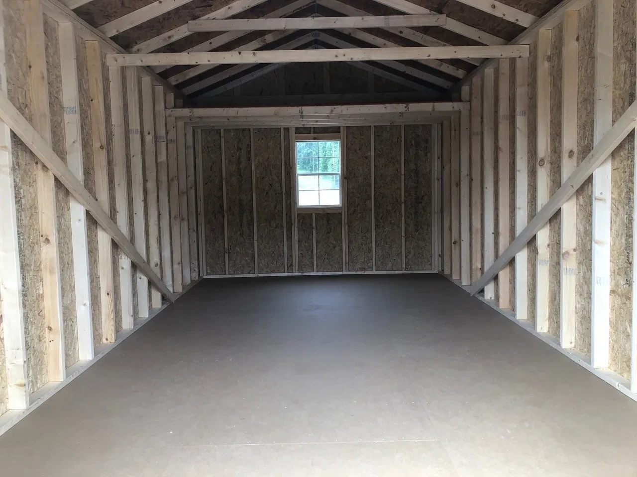interior of 10x20 utility shed showing a window and a loft
