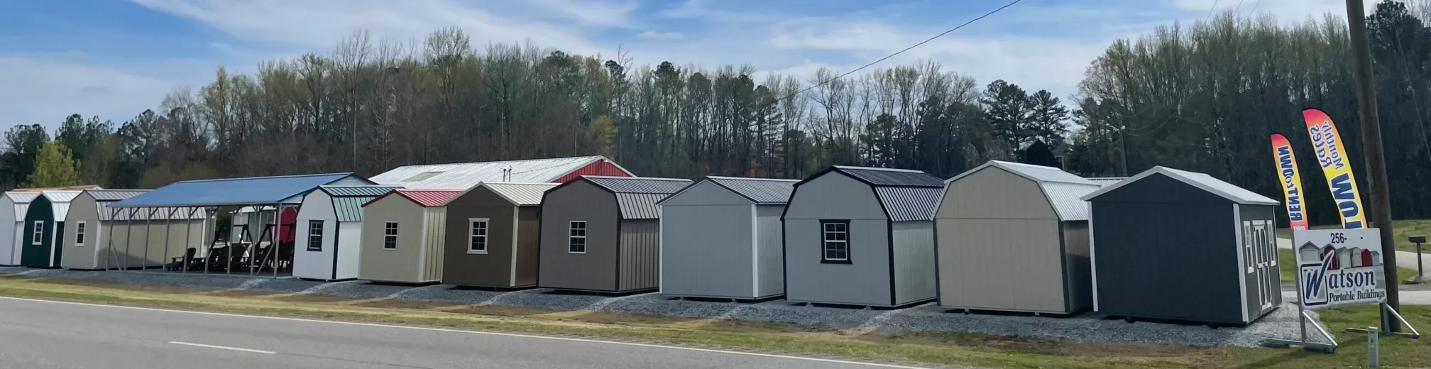 row of sheds and carports at the madison sales lot as seen from the road