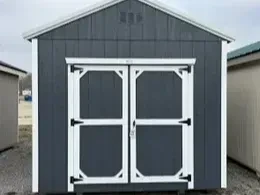the a slate gray utility shed with double doors and a roof overhang, it also has white roof trim and white wall trim