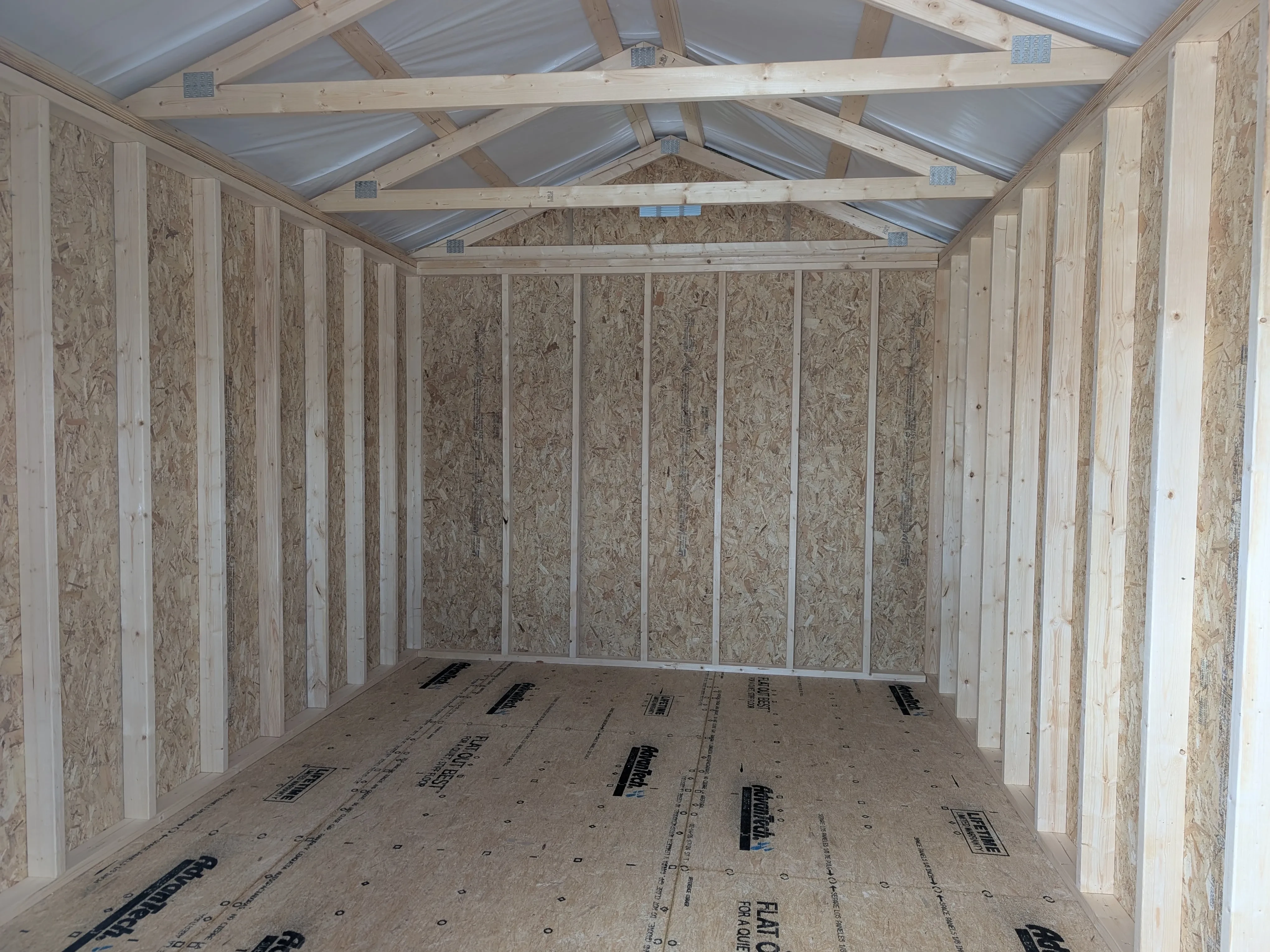 inside a wood utility shed looking at the back wall