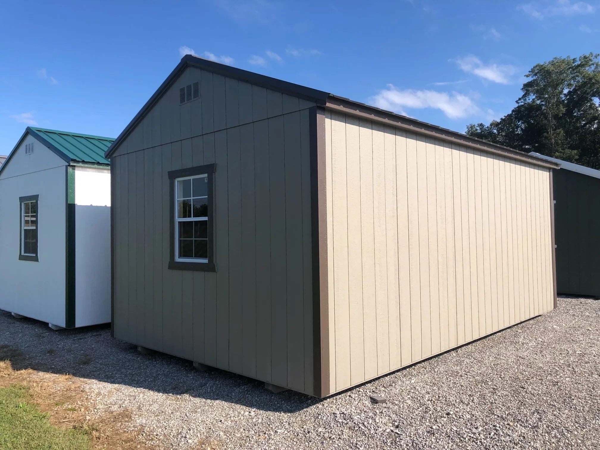 The back side view of a shed showing a window in the back wall