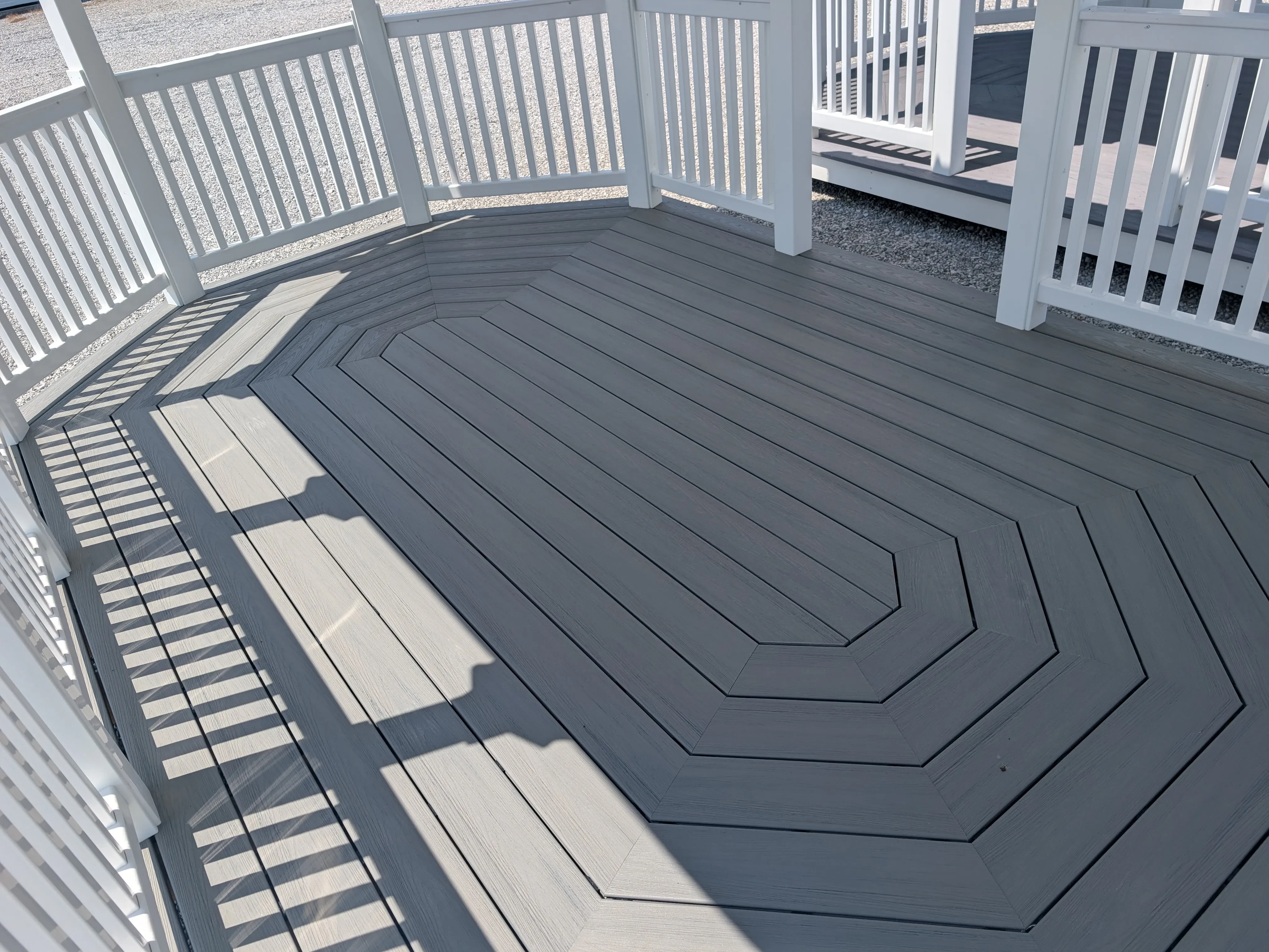 looking down at the polywood decking floor of a white vinyl gazebo