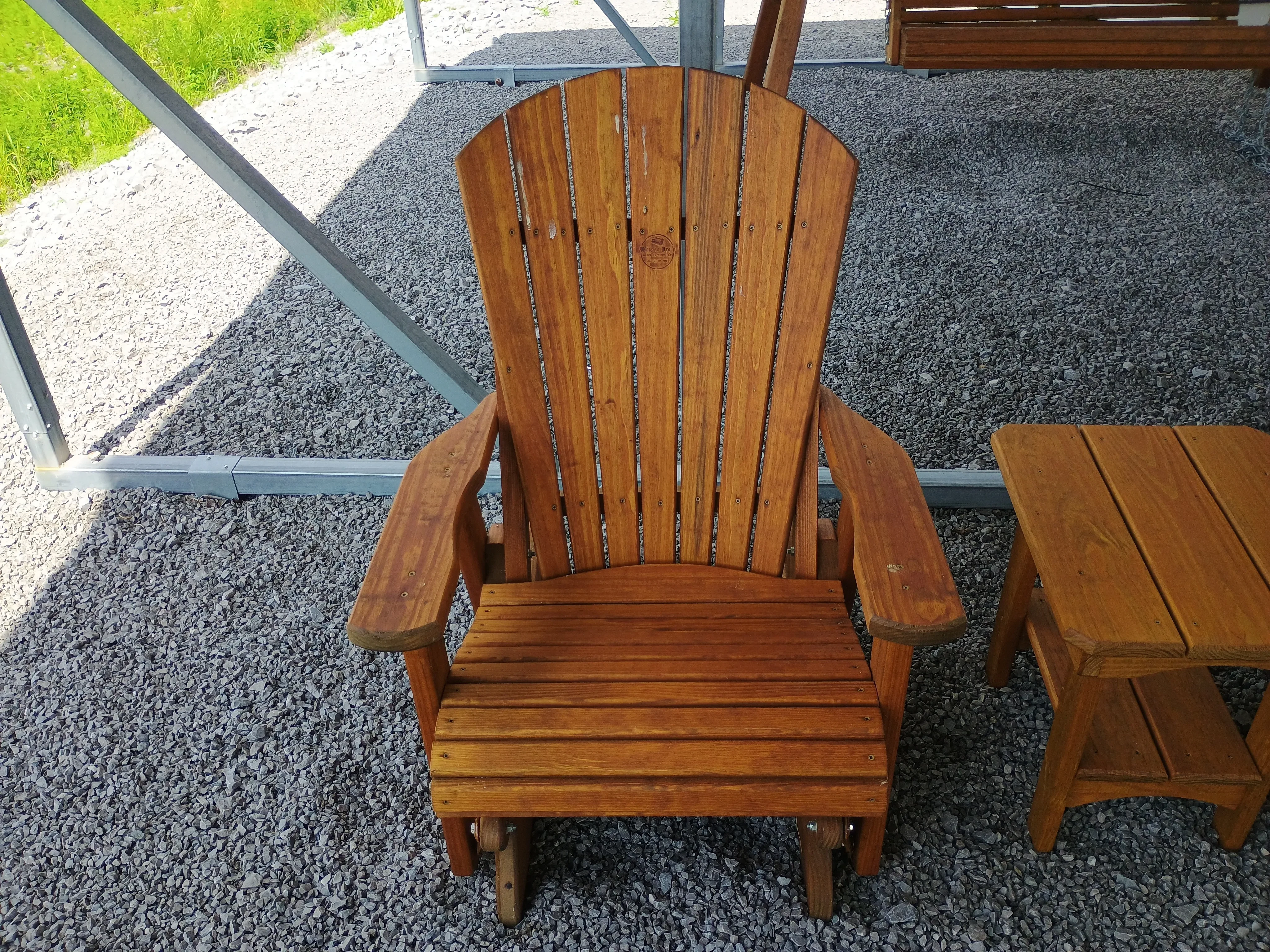 wood stained and sealed single adirondack glider