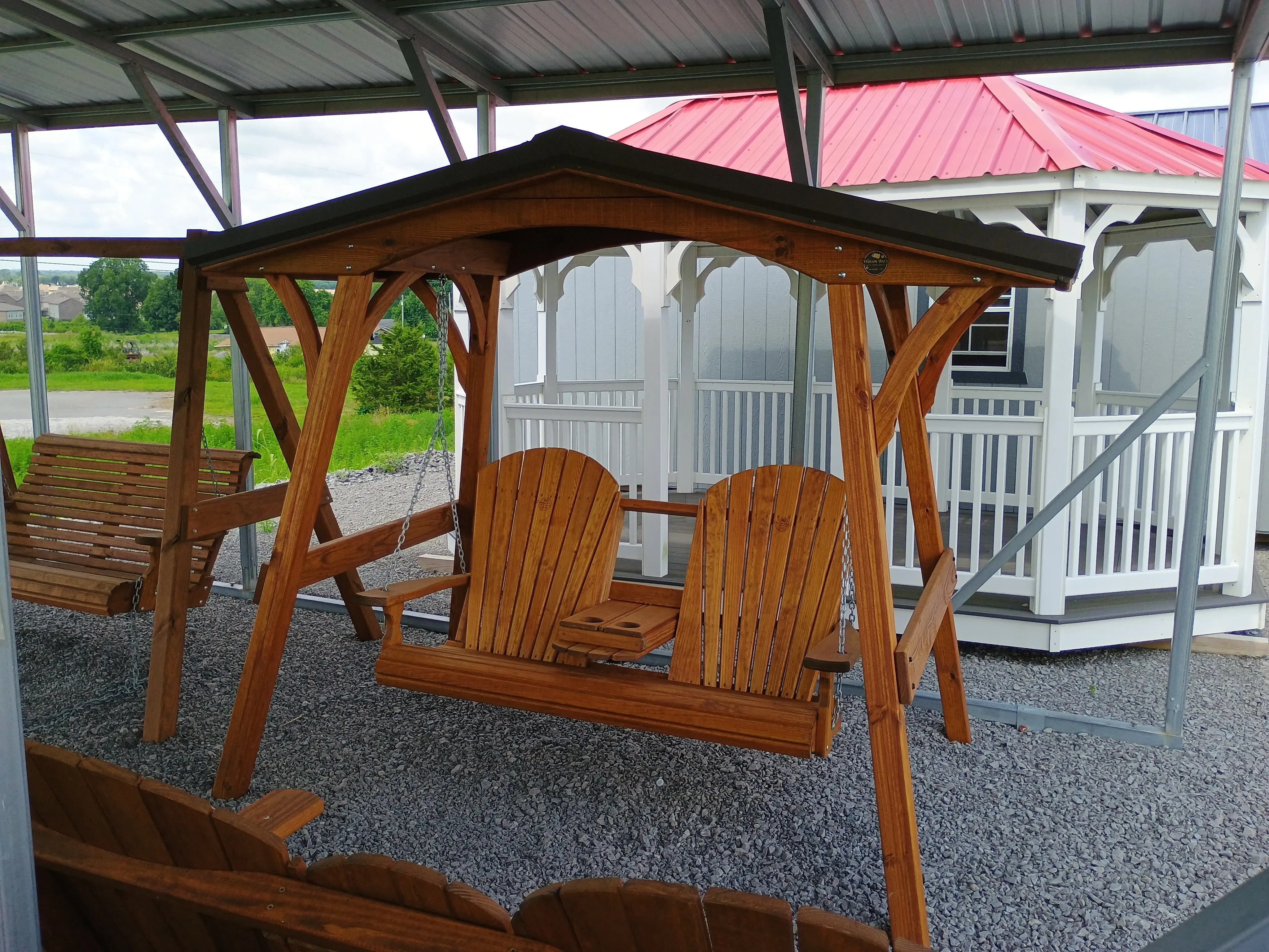 wood stained and sealed swing cover with metal roof