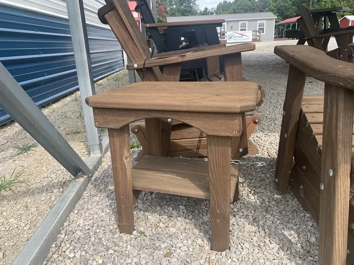 a small wooden end table sitting on gravel. It is stained and sealed