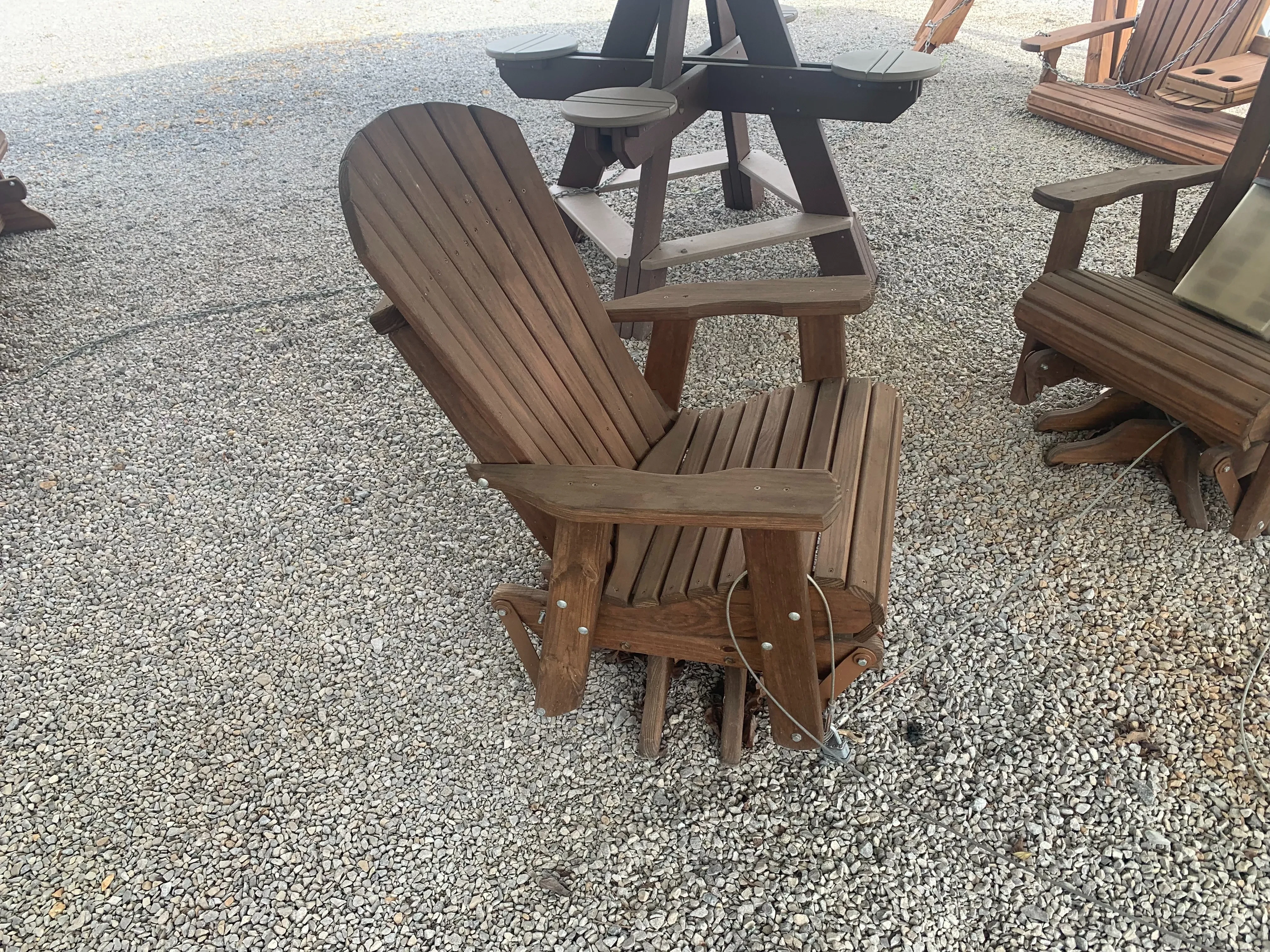 a wood stained and sealed chari that can swivel 360° and glides back and forth