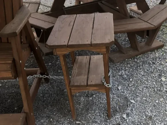 a wood end table that is stained and sealed and is next to another chair and a table