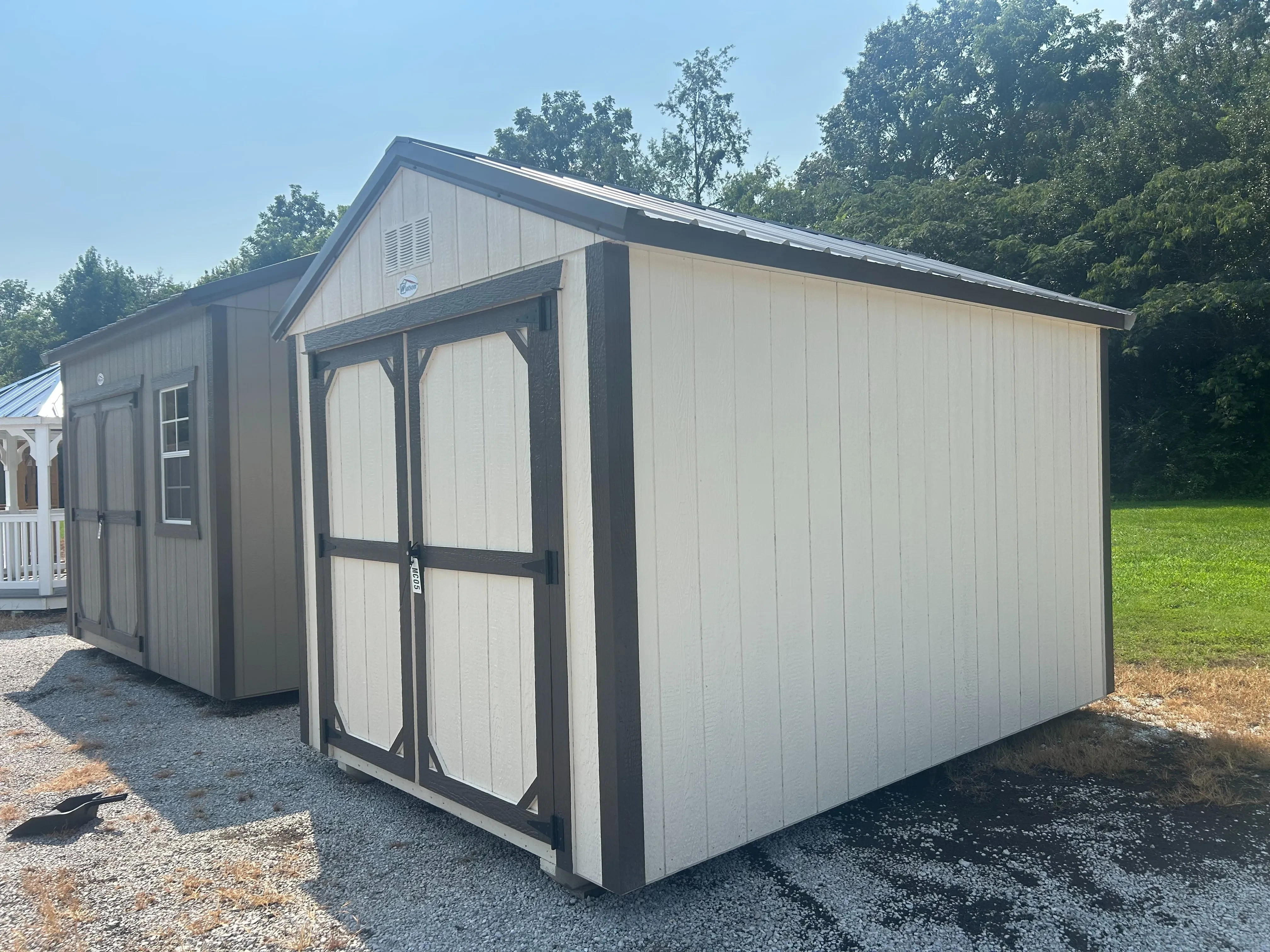 An 8x12 classic wood utility shed in Navajo White and Bronze
