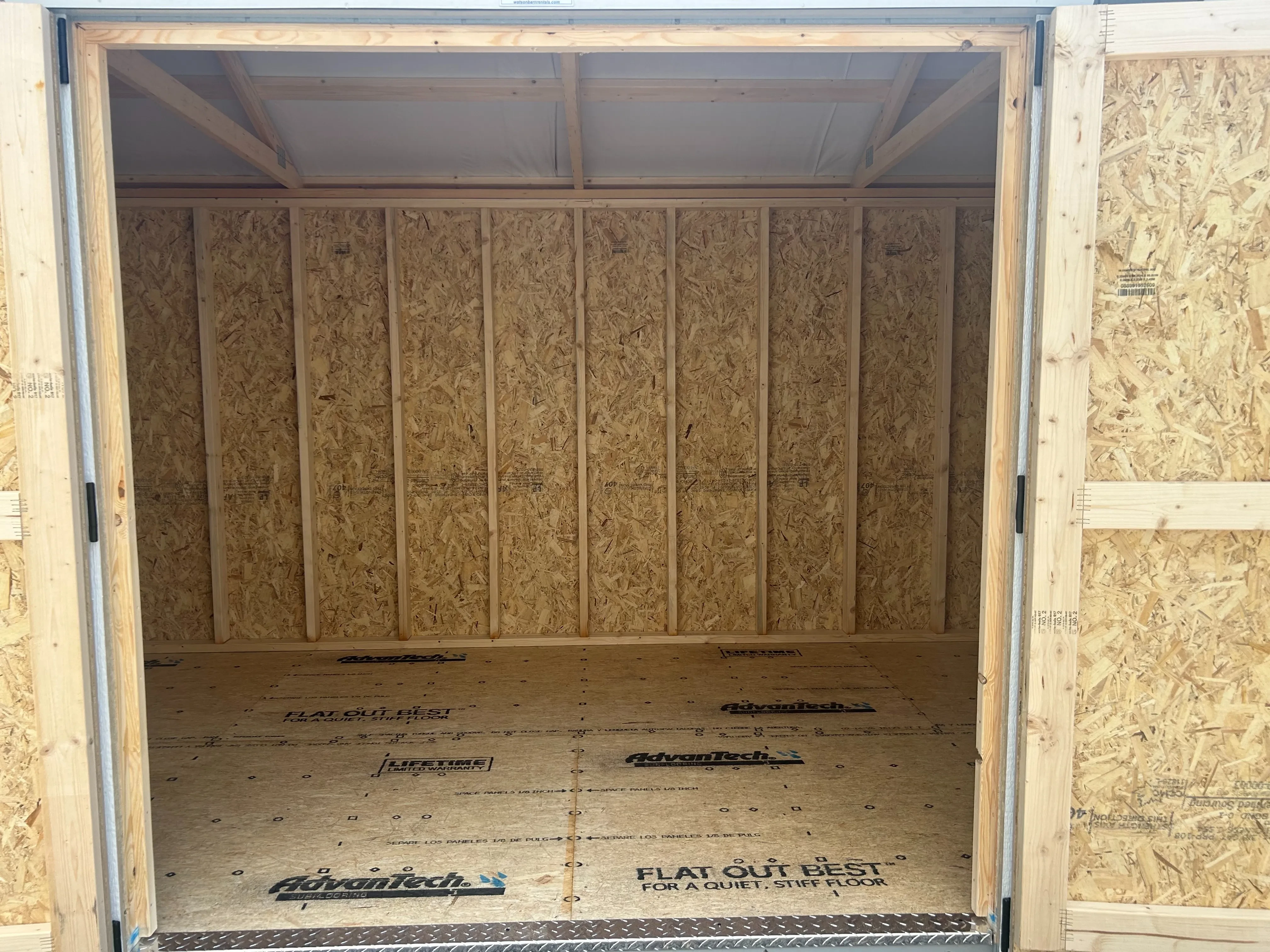 The inside of an 8x16 wooden garden shed showing diamond plate entry