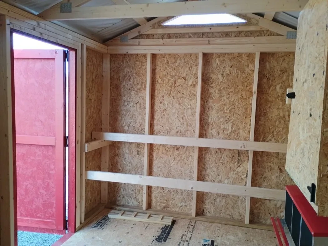 Inside of 8x12 chicken coop, showing roosts.