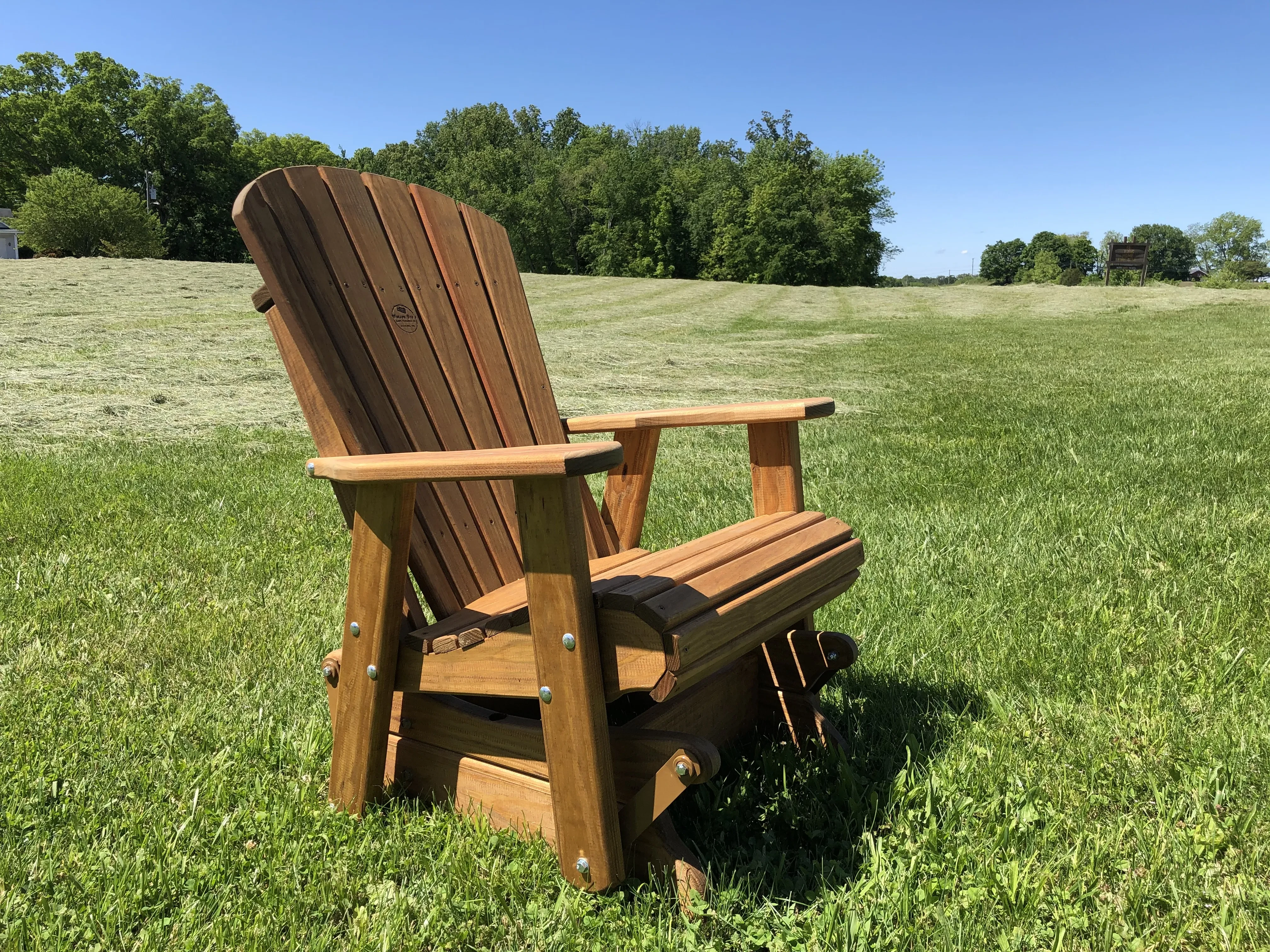 Wood Outdoor Glider sitting in the grass