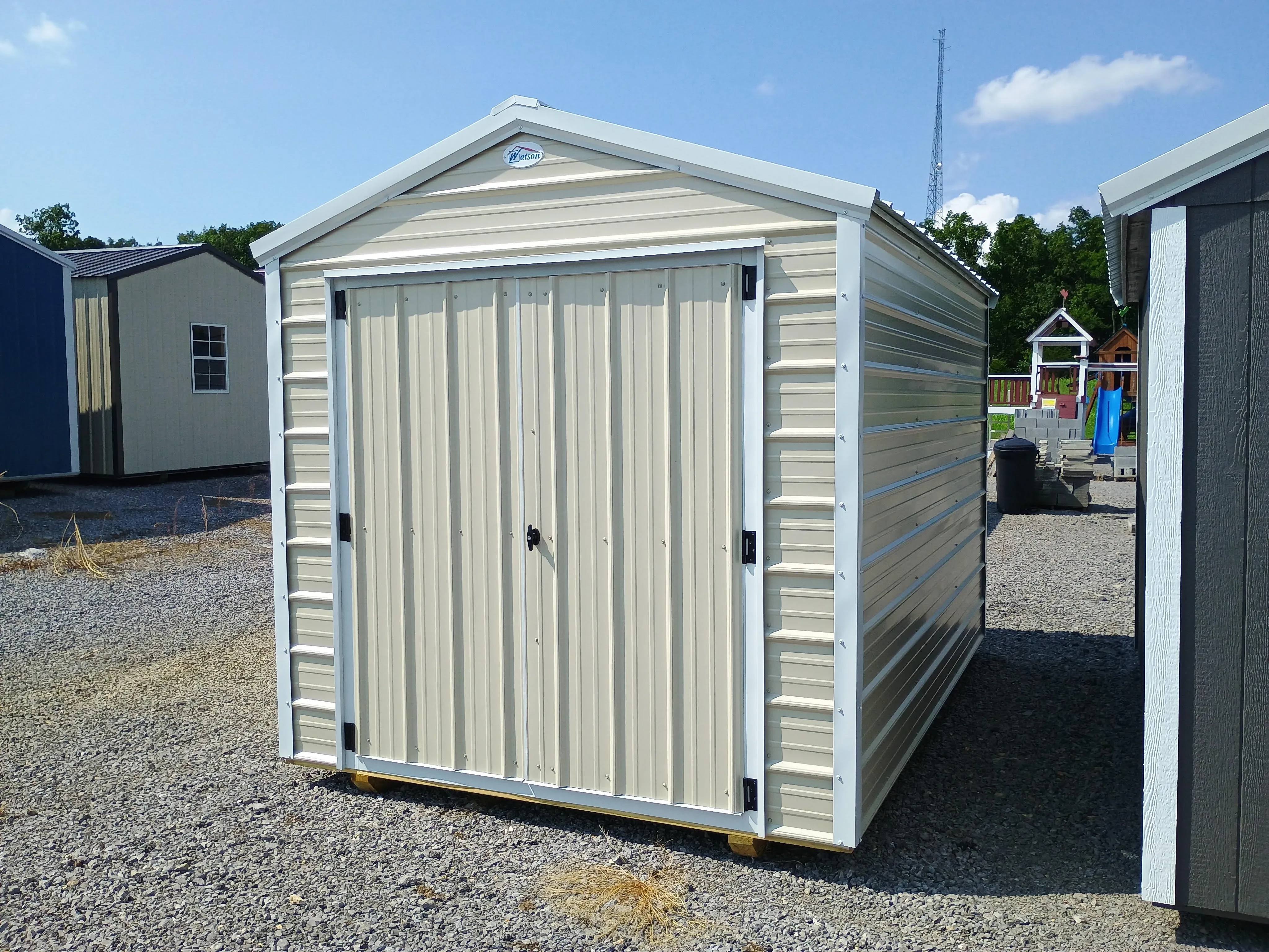 Outside of 8x12 value metal utility shed, with stone siding and polar white trim and roof.
