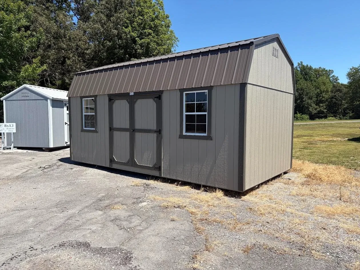 side view of the wood side lofted barn clay siding with bronze roof & trim