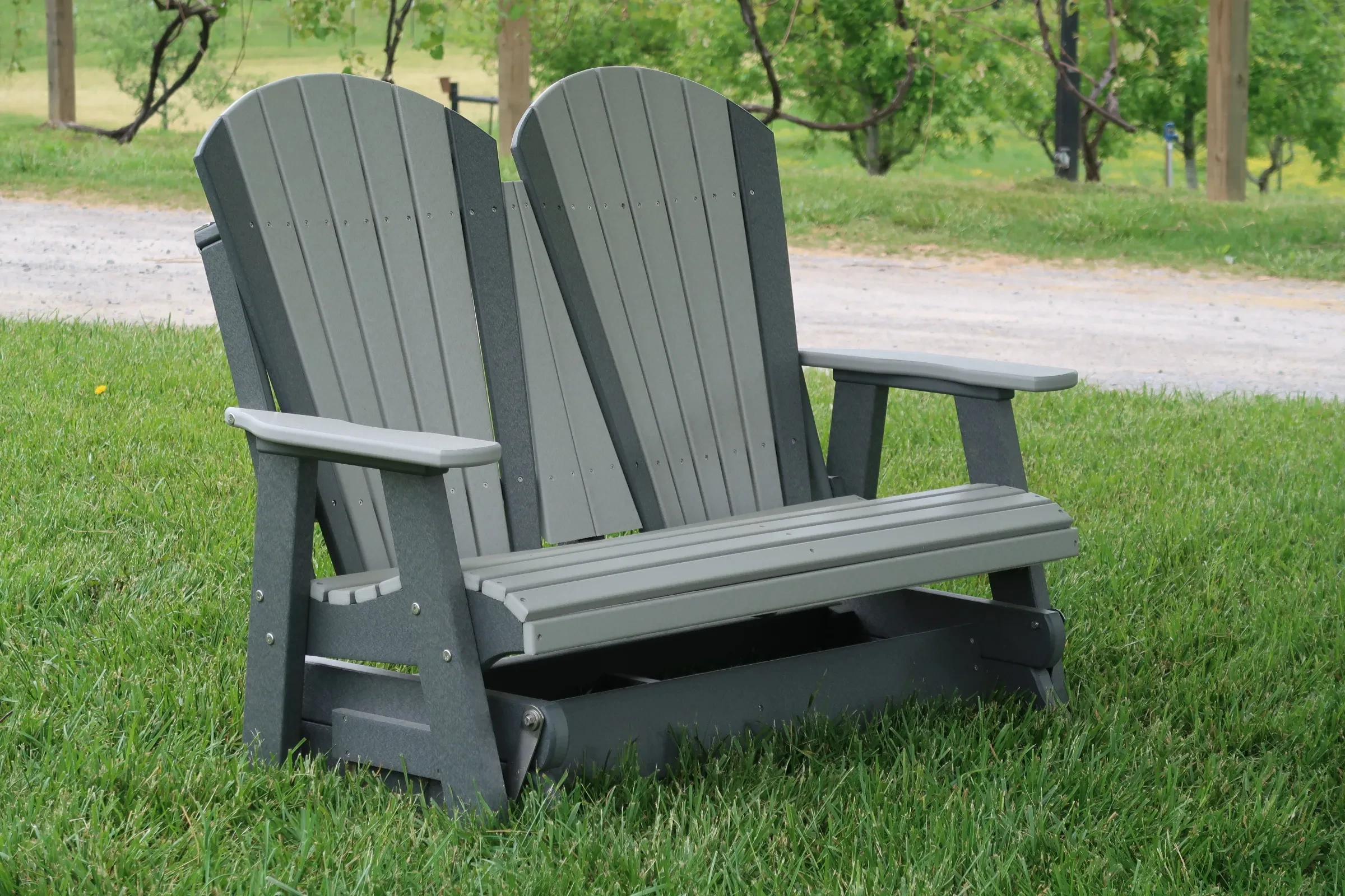 Polywood Outdoor Glider sitting in the grass