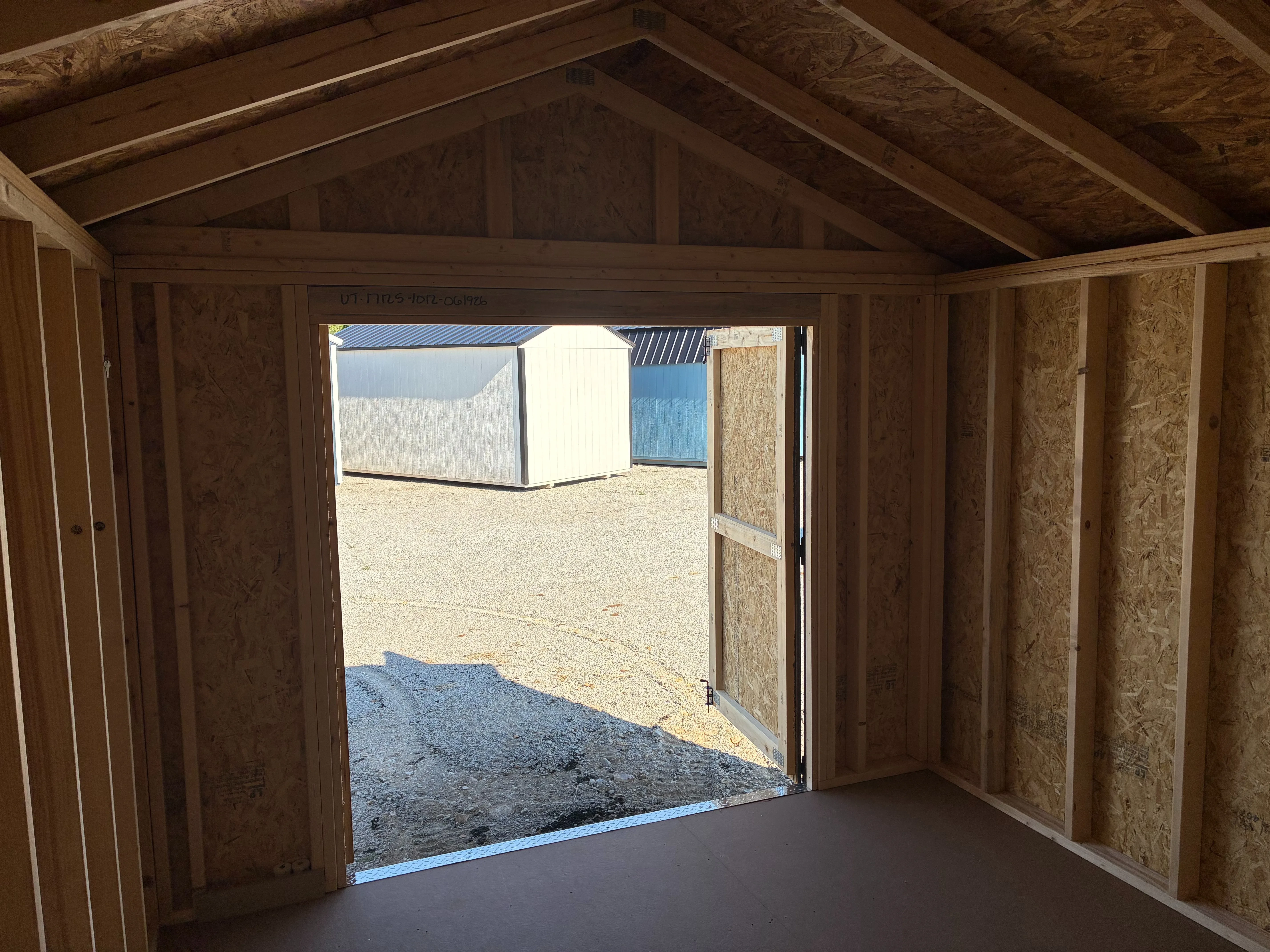 interior of 10x12 utility shed showing walls and double doors