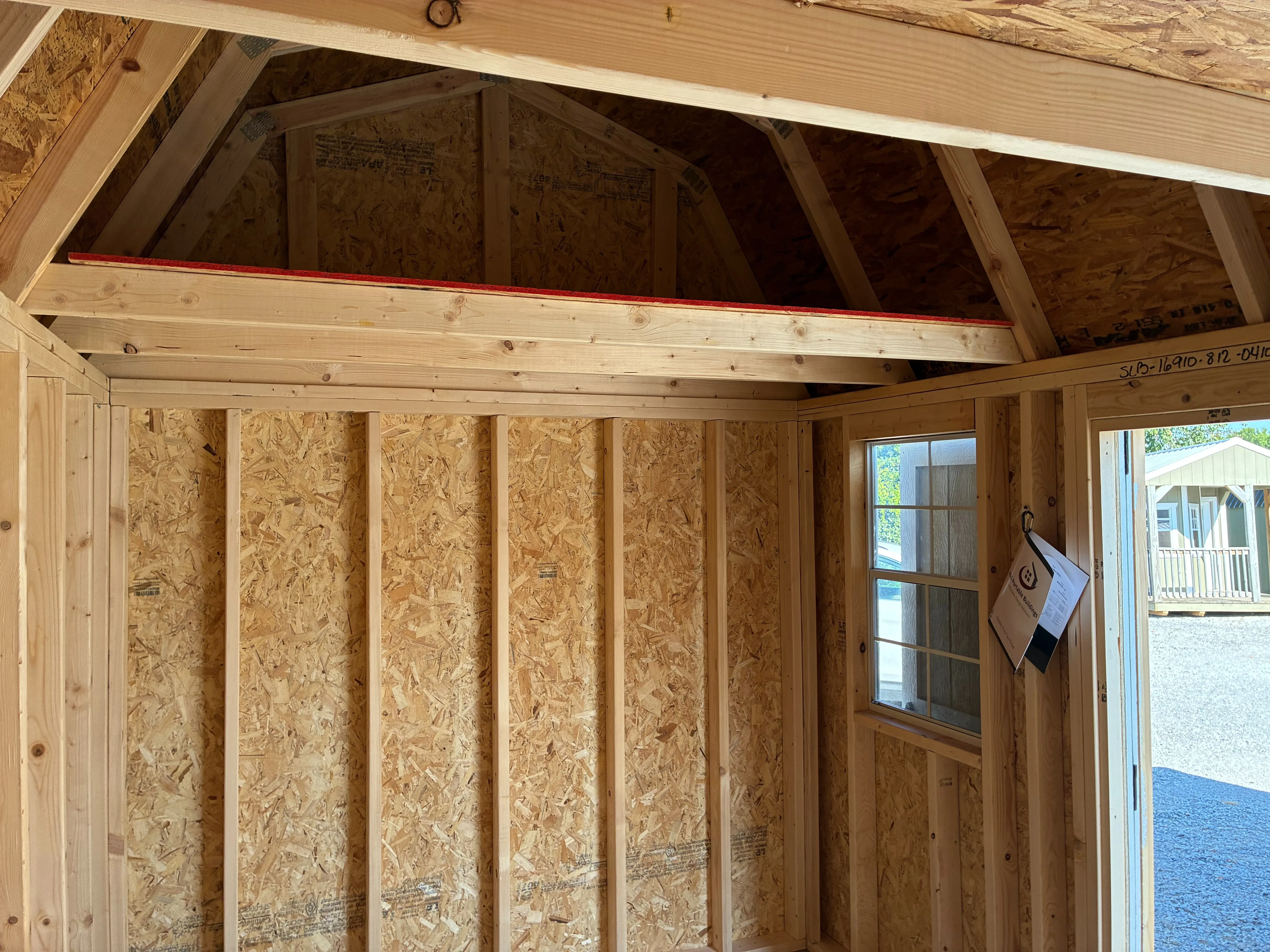 interior of side lofted barn showing window and loft